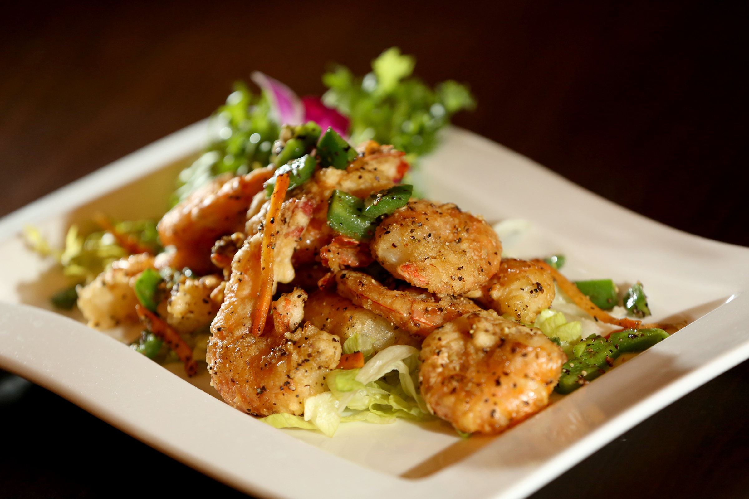 Salt and Pepper Shrimp, served with green pepper and jalepeno, is a Chinese specialty at Ozu 852. The restaurant has won the Best Asian Food category in the Best of Dayton contest for numerous years. Located at 852 Union Blvd. in Englewood, the restaurant is known for fresh, quality sushi, hibachi, Chinese and Japanese foods. LISA POWELL / STAFF