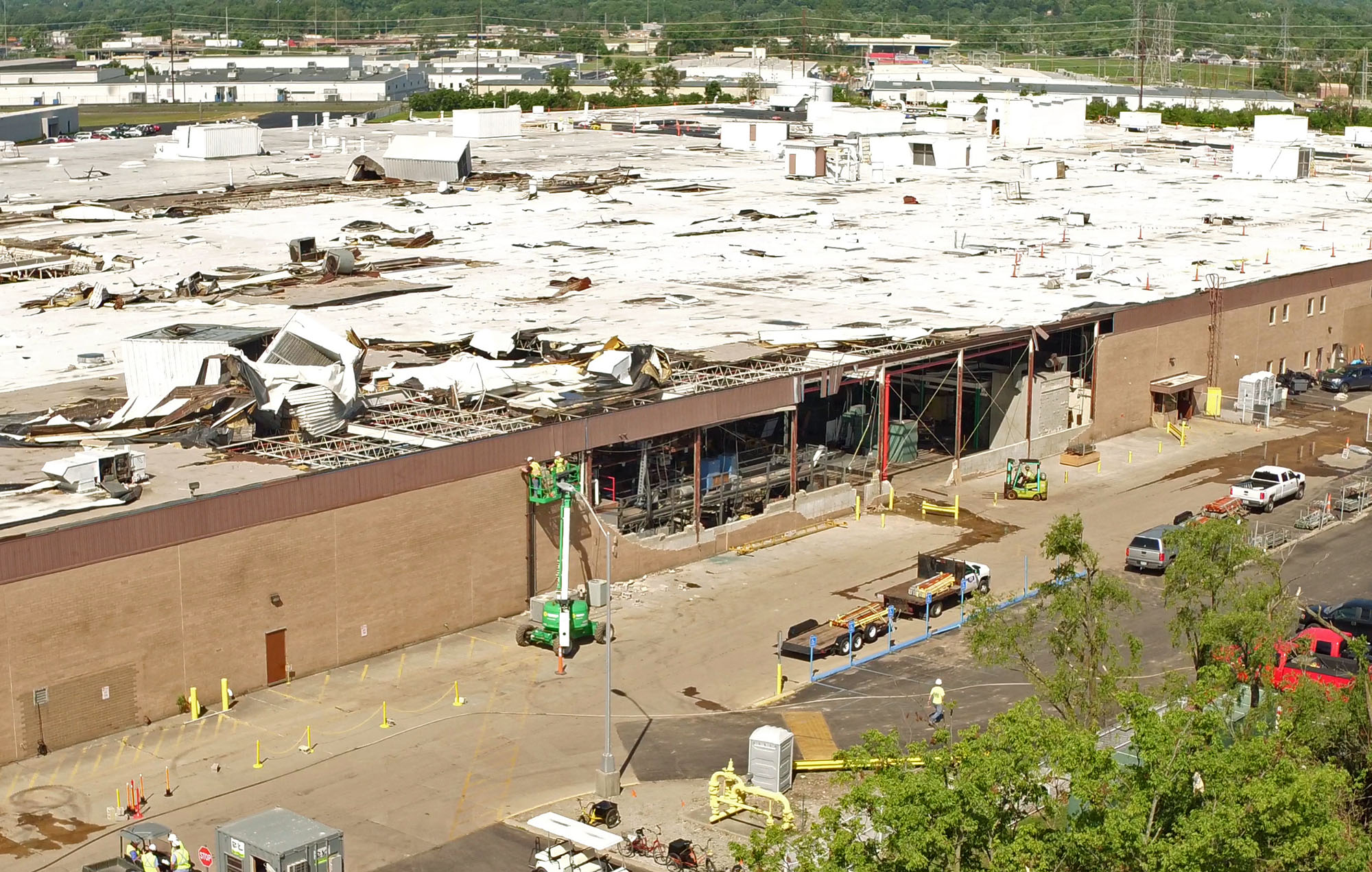 Aerial view looking northwest at the nearly 650,000 square foot Dayton Phoenix Group building on Kuntz Road in the Old North Dayton business park. The roof and walls were severely damaged by a tornado on Memorial Day.Construction workers are beginning restoration work. TY GREENLEES / STAFF