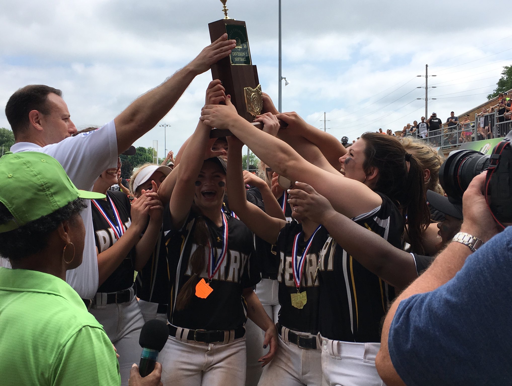 The Massillon Perry Panthers accept the Division I state championship trophy from the Ohio High School Athletic Association’s Tim Stried after defeating Lakota West 11-1 on Saturday afternoon at Firestone Stadium in Akron. RICK CASSANO/STAFF
