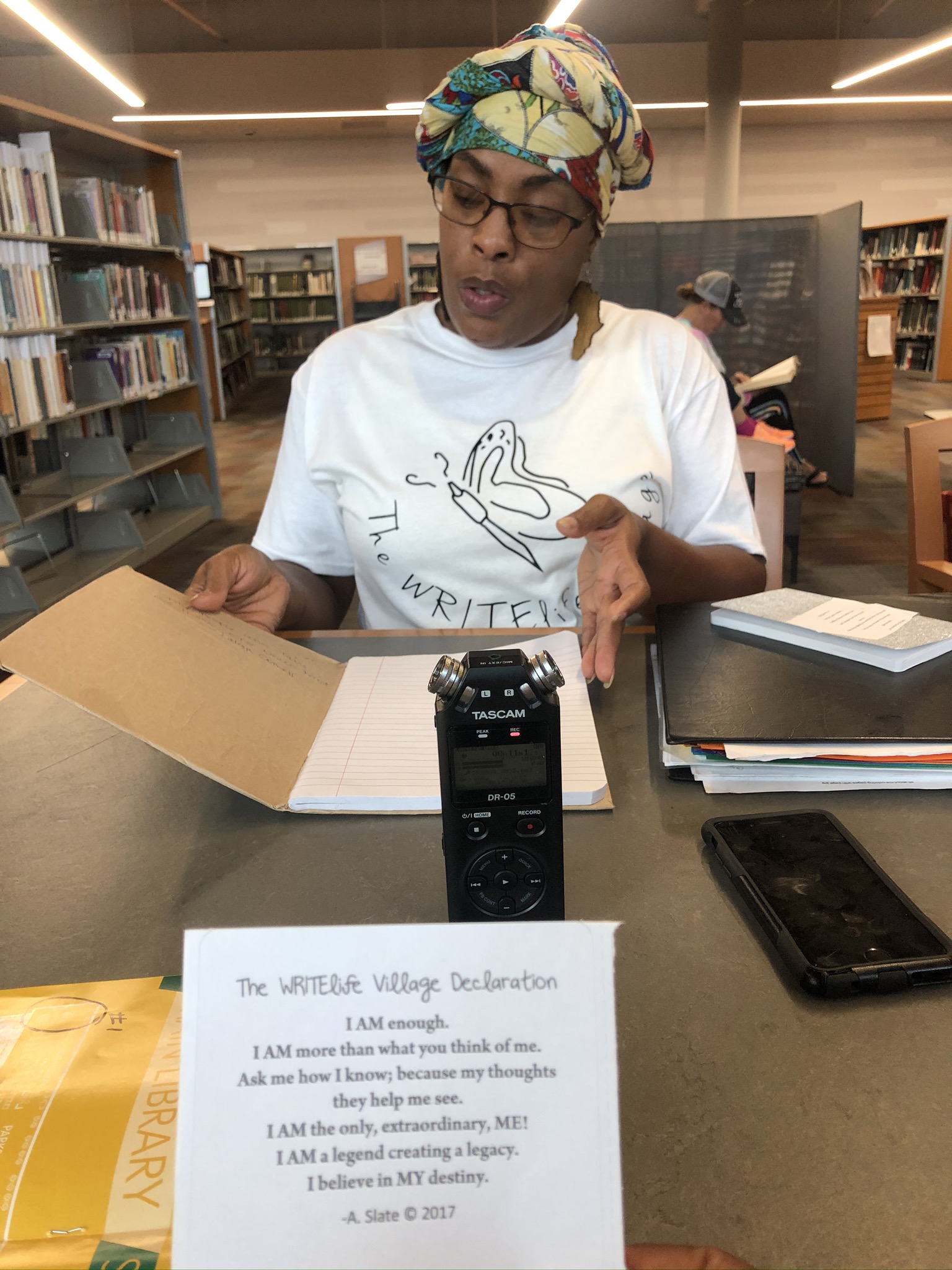 Dayton area resident shared stories of survival as part of the Dayton Strong Storytelling Sessions recorded at the Dayton Metro Library. Latesa Williamson, the Dayton poet and performer known as A Slate, of The WRITElife Village is pictures. She holds a book of poems written by children following the tornadoes.