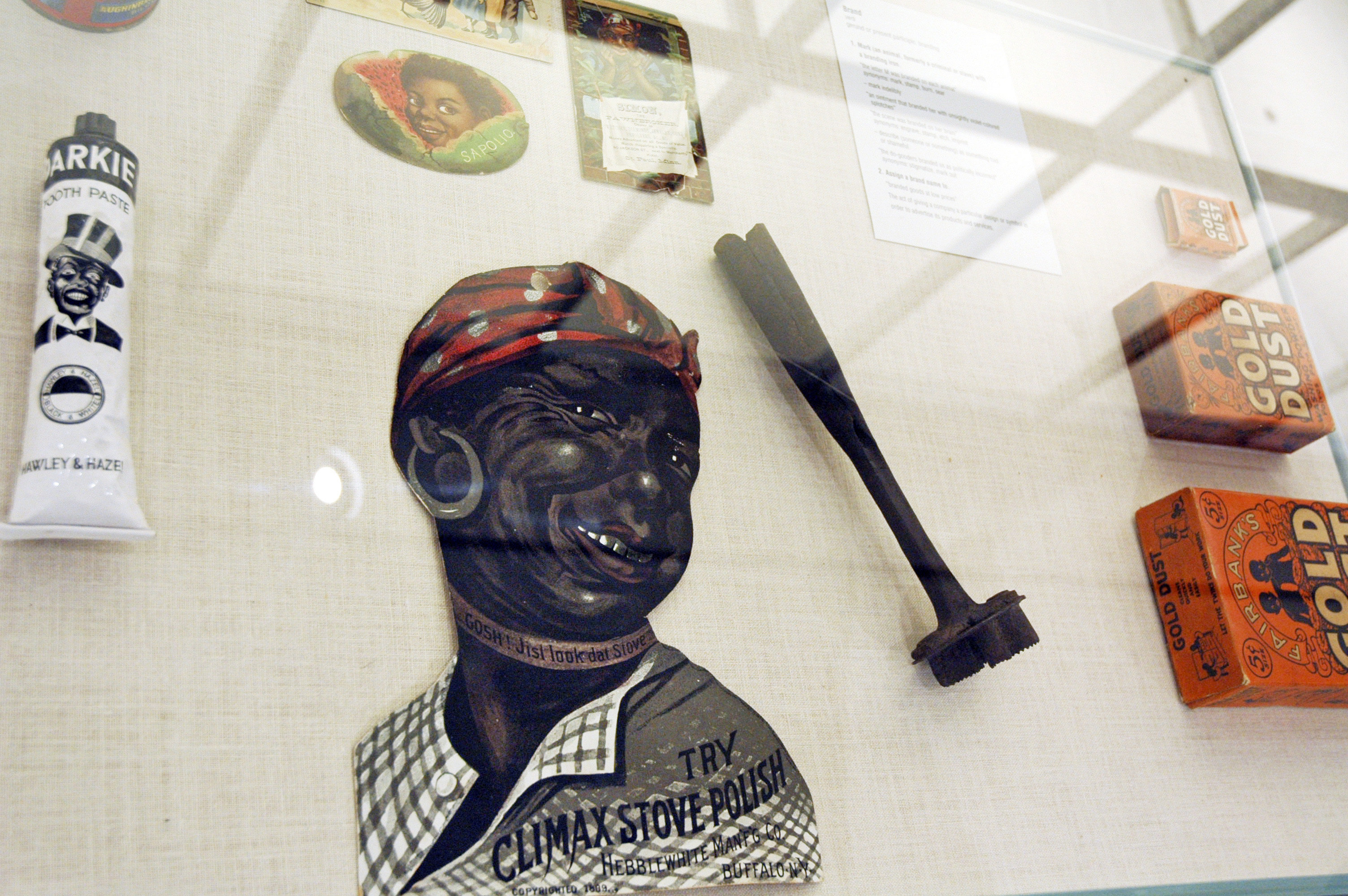 In this Jan. 11, 2018 photo, artifacts inside a display case, including a branding iron, are included in the slavery and segregation collection by Alan Page, NFL Hall of Famer and retired Minnesota Supreme Court Justice, and his wife, Diane Sims Page, displayed at the Minneapolis Central Library this month in time for Super Bowl visitors and thousands of other people expected to flock to downtown for the festivities. (AP Photo/Steve Karnowski)