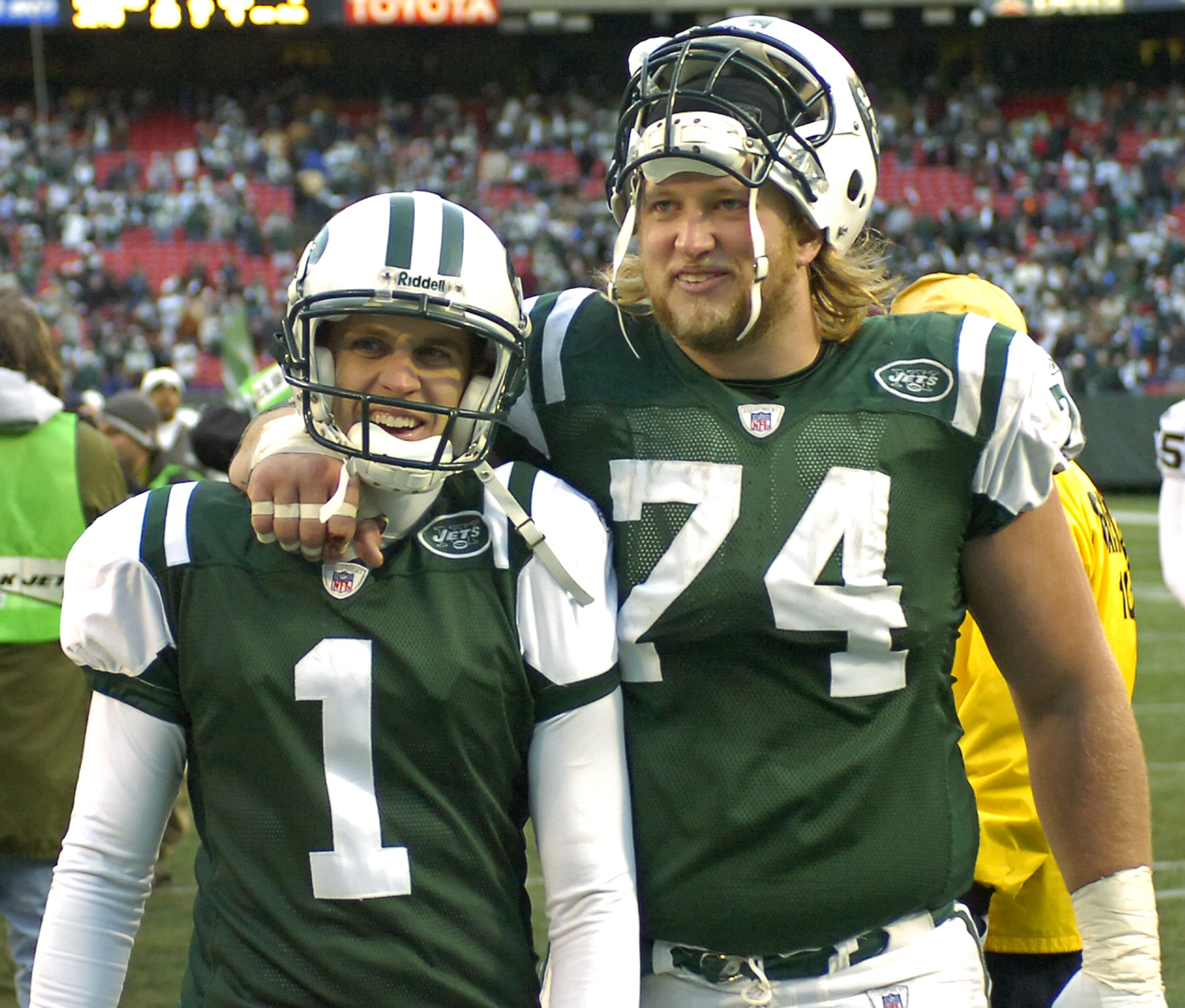 New York Jets center Nick Mangold (74, Alter) and kicker Mike Nugent (Centerville) leave the field after beating the Oakland Raiders, 23-3, to make the playoffs during NFL football Sunday, Dec. 31, 2006 at Giants Stadium in East Rutherford, N.J. (AP Photo/Bill Kostroun)