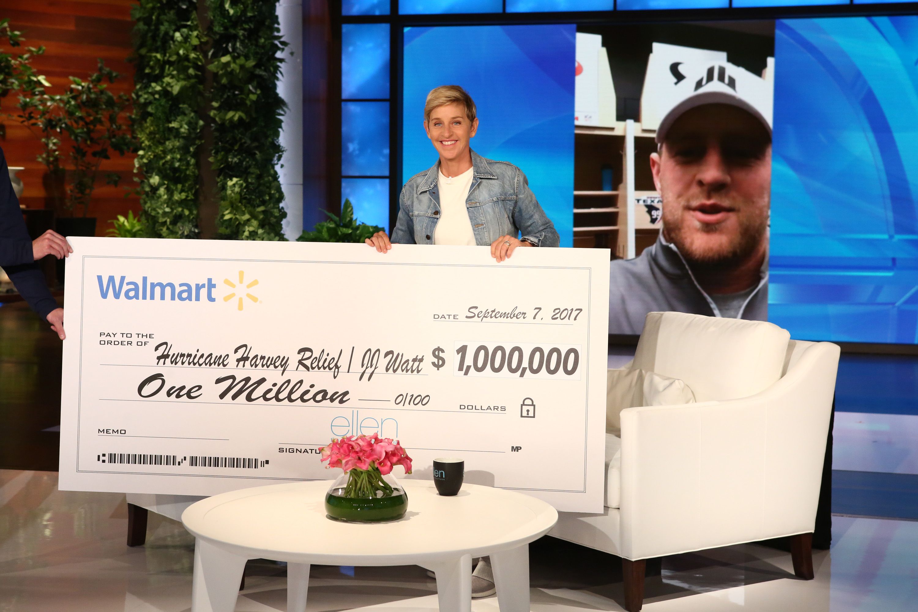 Ellen DeGeneres presents a check for $1 million to football player J.J. Watt on an episode of her talk show airing Sept. 7.