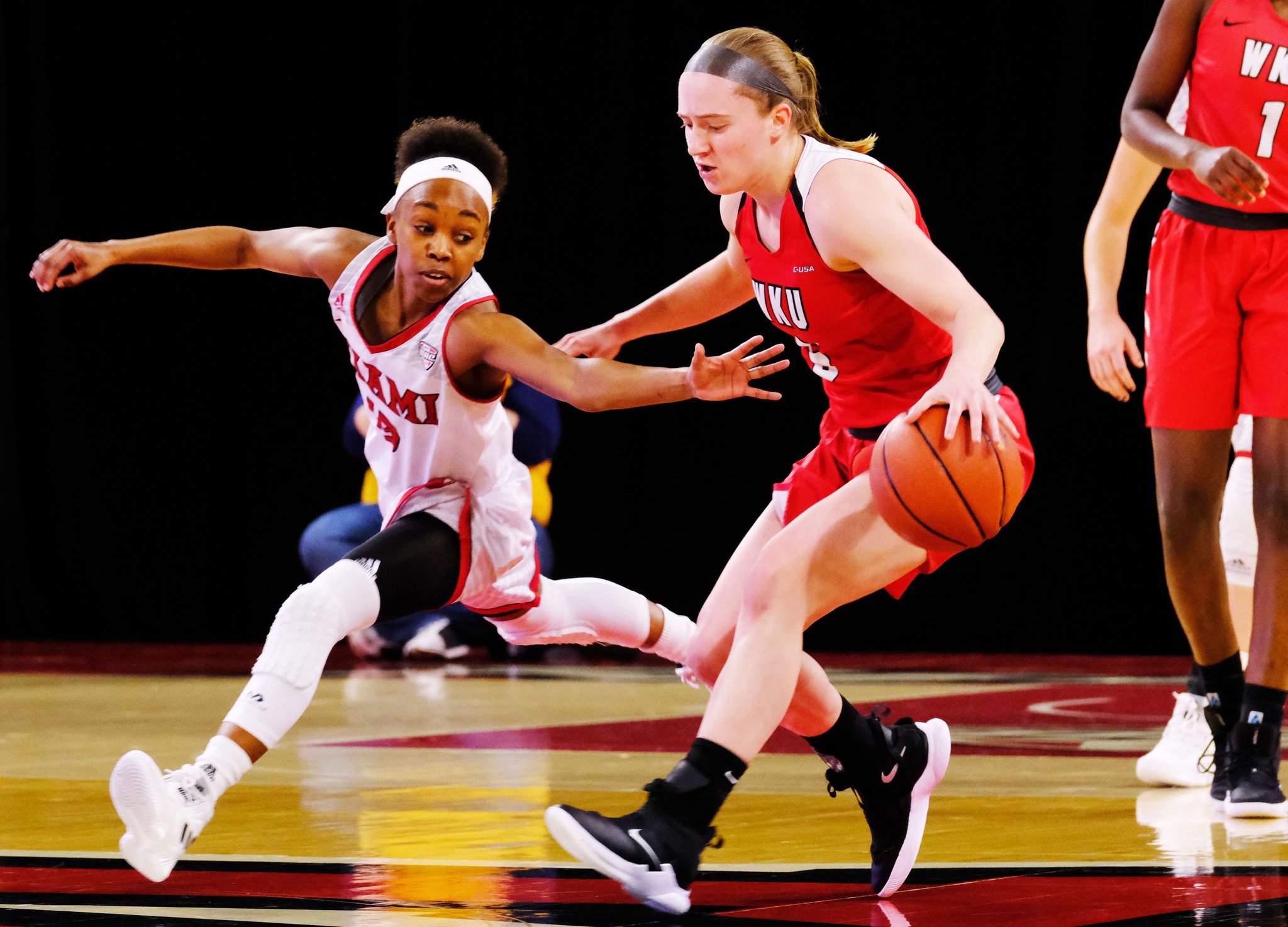 Miami University’s Lauren Dickerson defends Western Kentucky’s Whitney Creech during Thursday night’s WNIT game at Millett Hall in Oxford. WKU won 67-63. SCOTT KISSELL/MIAMI UNIVERSITY