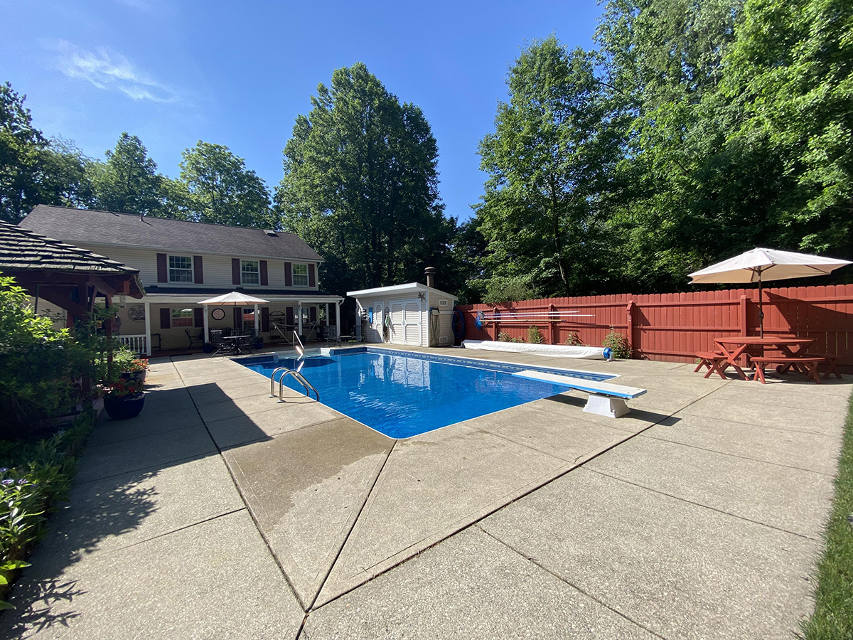 The rear yard has an in-ground pool with diving board, covered back deck, privacy fence, pool house and detached, 1-car garage with a workshop and separate apartment. CONTRIBUTED PHOTO
