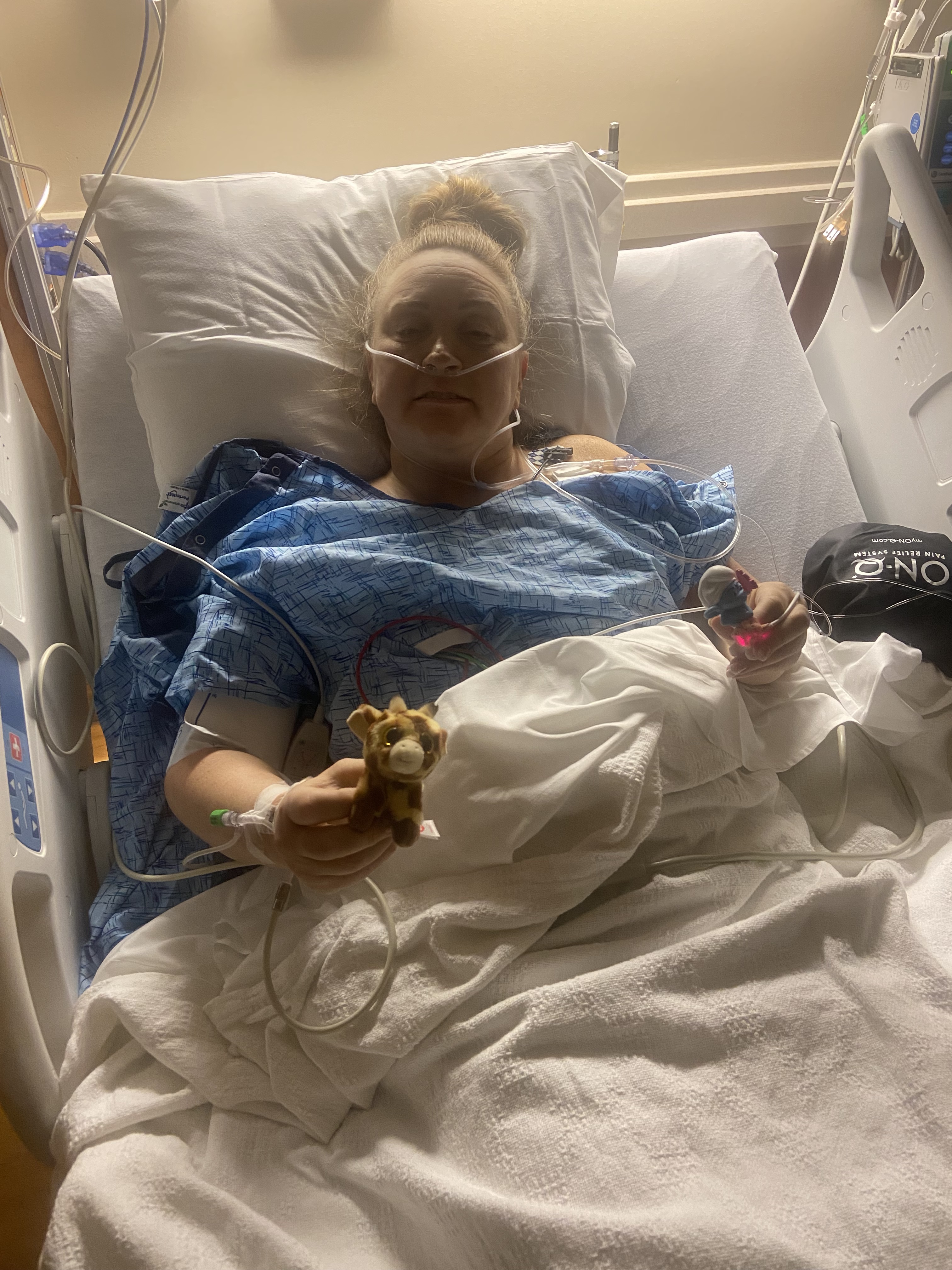 Melissa LaPeer in recovery after her double mastectomy on March 7. In her left hand she holds a character from 