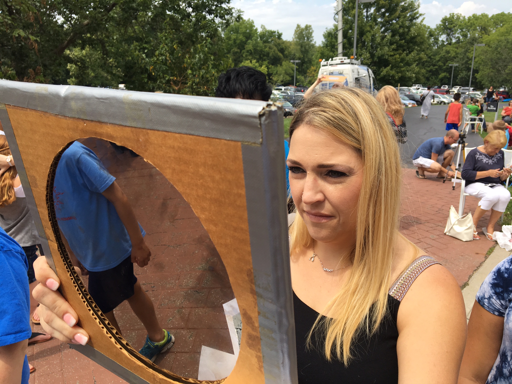 Vanessa Bowling of Springboro joined her three children at the Boonshoft Museum of Discovery to witness the solar eclipse Monday. CHRIS STEWART / STAFF