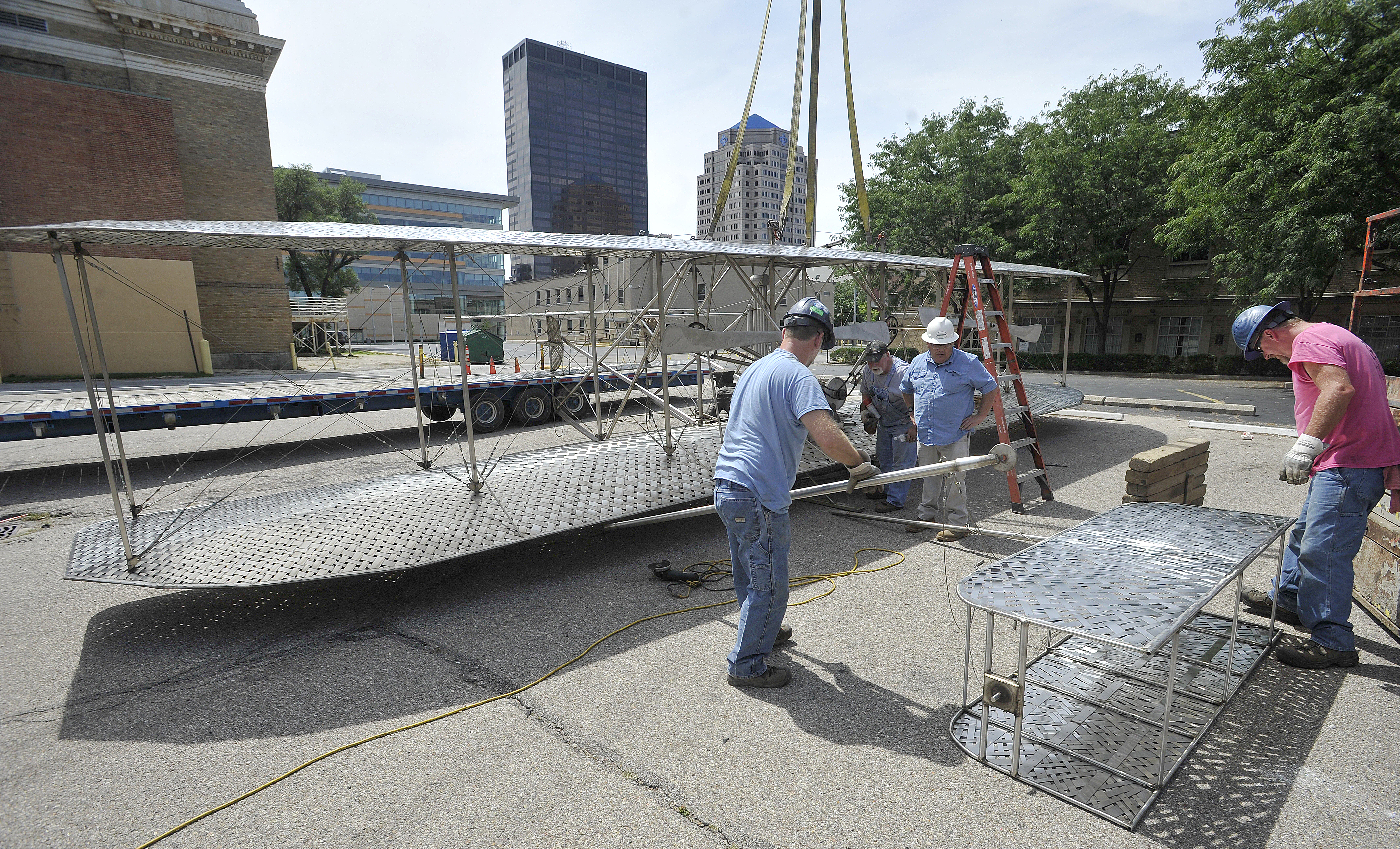 Workers for Schumacher Crane moved the Wright Brothers sculpture that has been on Monument Avenue across from Riverscape Metro Park for nearly two decades. The sculpture was moved to allow for redevelopment of the Monument Avenue site. MARSHALL GORBY/STAFF