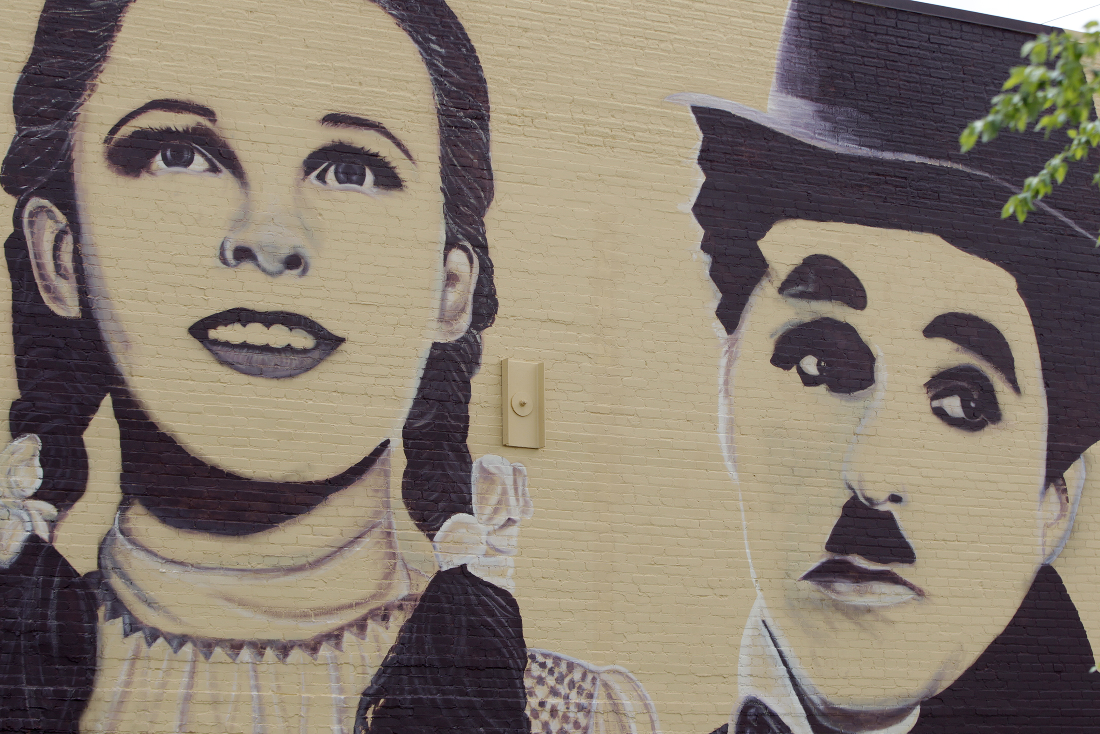 A new mural in downtown Miamisburg pays tribute to Hollywood legends. Towering portraits - 35- feet tall - of John Wayne, Carrie Fisher, Paul Newman, Judy Garland and Charlie Chaplain have been created on the north wall of the Plaza Theatre, 33 S. Main St. Artist Erica Arndts, a Centerville native, said she wanted to âpay honor to vintage Hollywood characters,â as she put the finishing touches on the 100-foot-long mural. LISA POWELL / STAFF