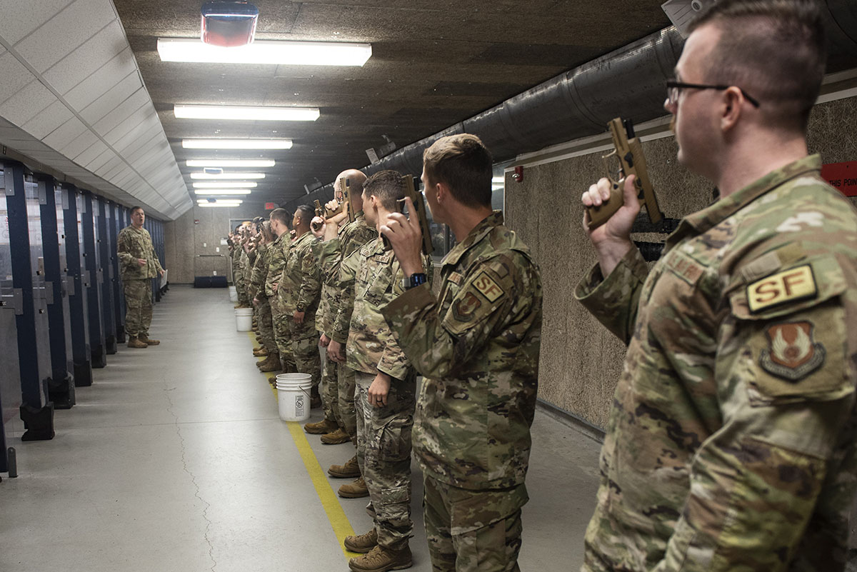 Participants listen to final instructions before beginning the firing portion of the Excellence in Competition shooting event held as part of Police Week at Wright-Patterson Air Force Base on May 17. During the competition participants competed for the best score with both pistols and rifles. U.S. AIR FORCE PHOTO/WESLEY FARNSWORTH
