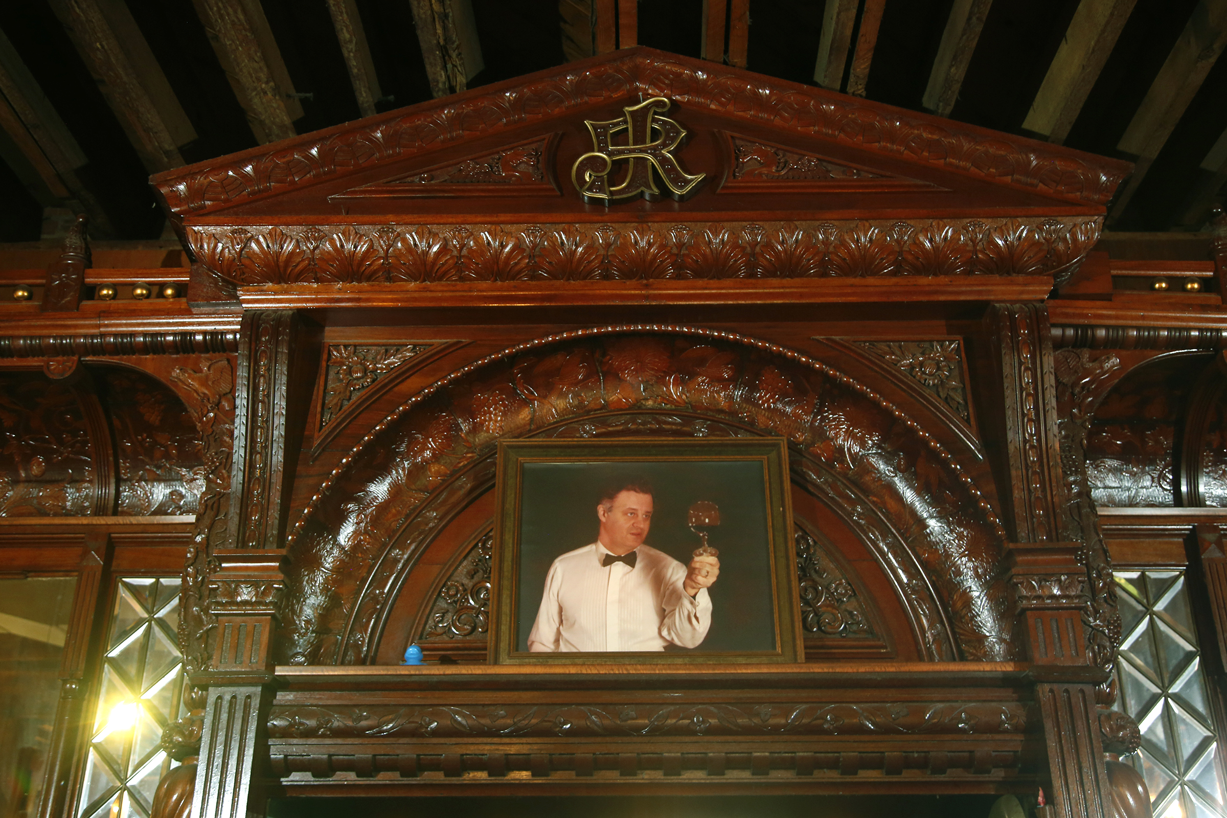 James Rittys initials are intertwined at the peak of the historic bar at Jay's Restaurant. Today, a painting of Jay Haverstick, who died in 2009, rests below them. LISA POWELL / STAFF