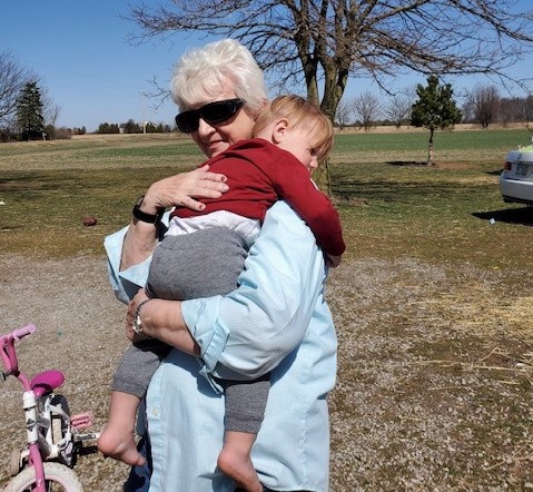 Marie Trittschuh hugs her 2-year-old great-grandson Harper Kosicki last weekend. They haven't seen each other throughout the pandemic except for the two funerals of Trittschuh's children, Harper's grandma and great-uncle, who died from COVID-19.
