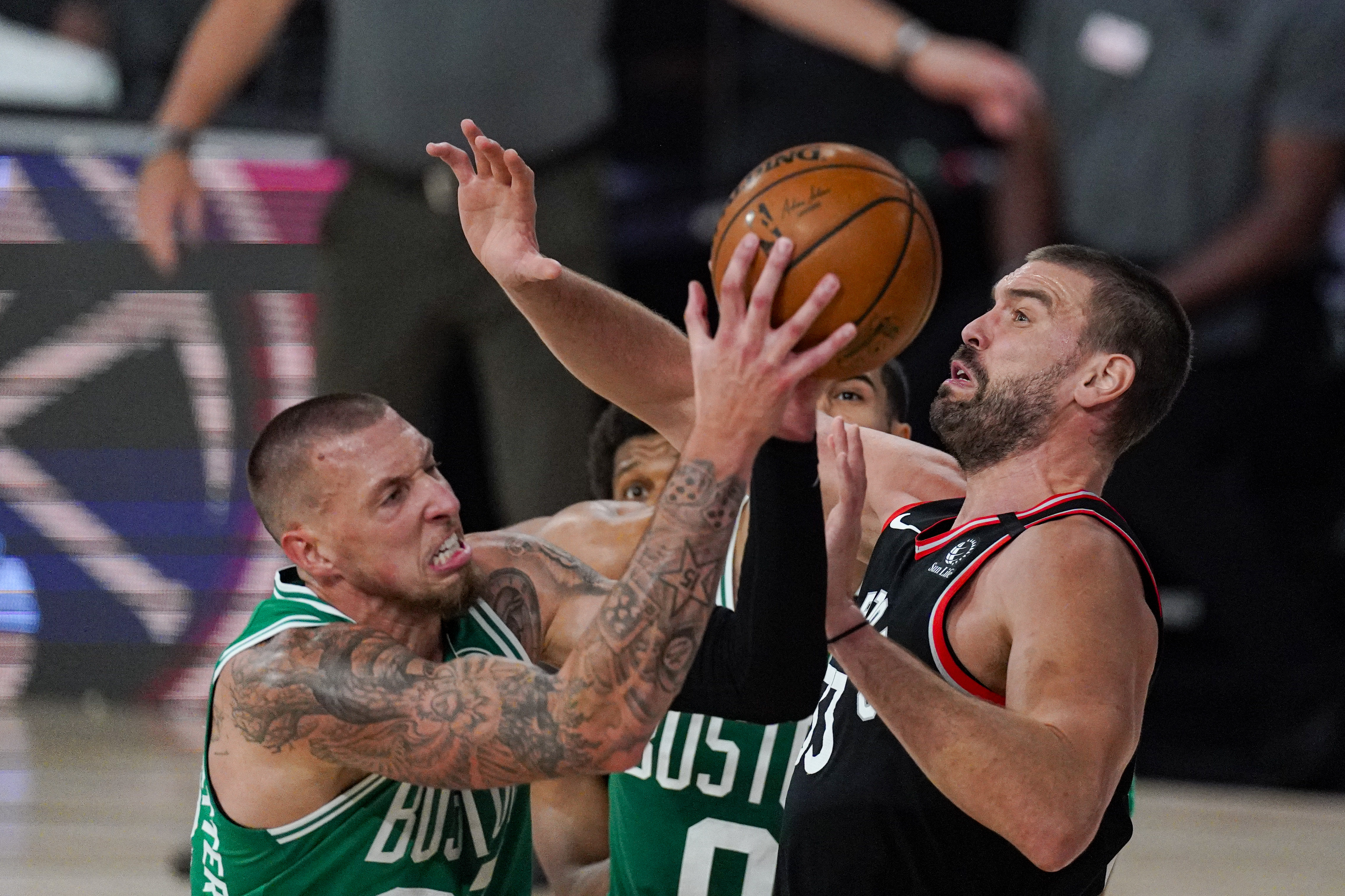 Boston Celtics center Daniel Theis (27) shoots over Toronto Raptors center Marc Gasol (33) during the second half of an NBA conference semifinal playoff basketball game Wednesday, Sept. 9, 2020, in Lake Buena Vista, Fla. (AP Photo/Mark J. Terrill)