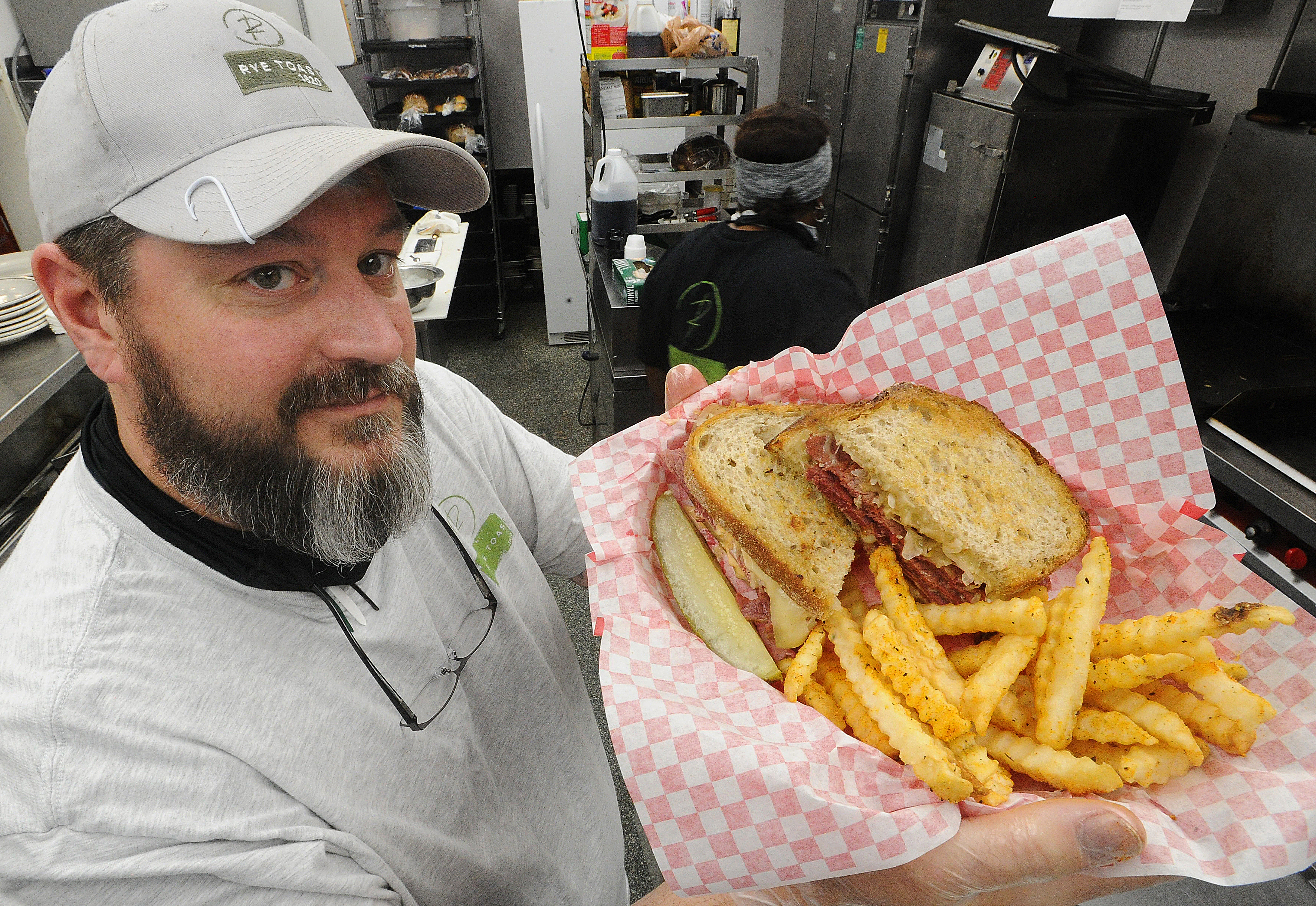 Chef Tom Tiner, owner of the Rye Toast Diner in Miamisburg, shows off his 1\3 lb. sliced corned beef with Swiss cheese, sauerkraut, Thousand Island dressig on griddled rye toast. MARSHALL GORBY\STAFF