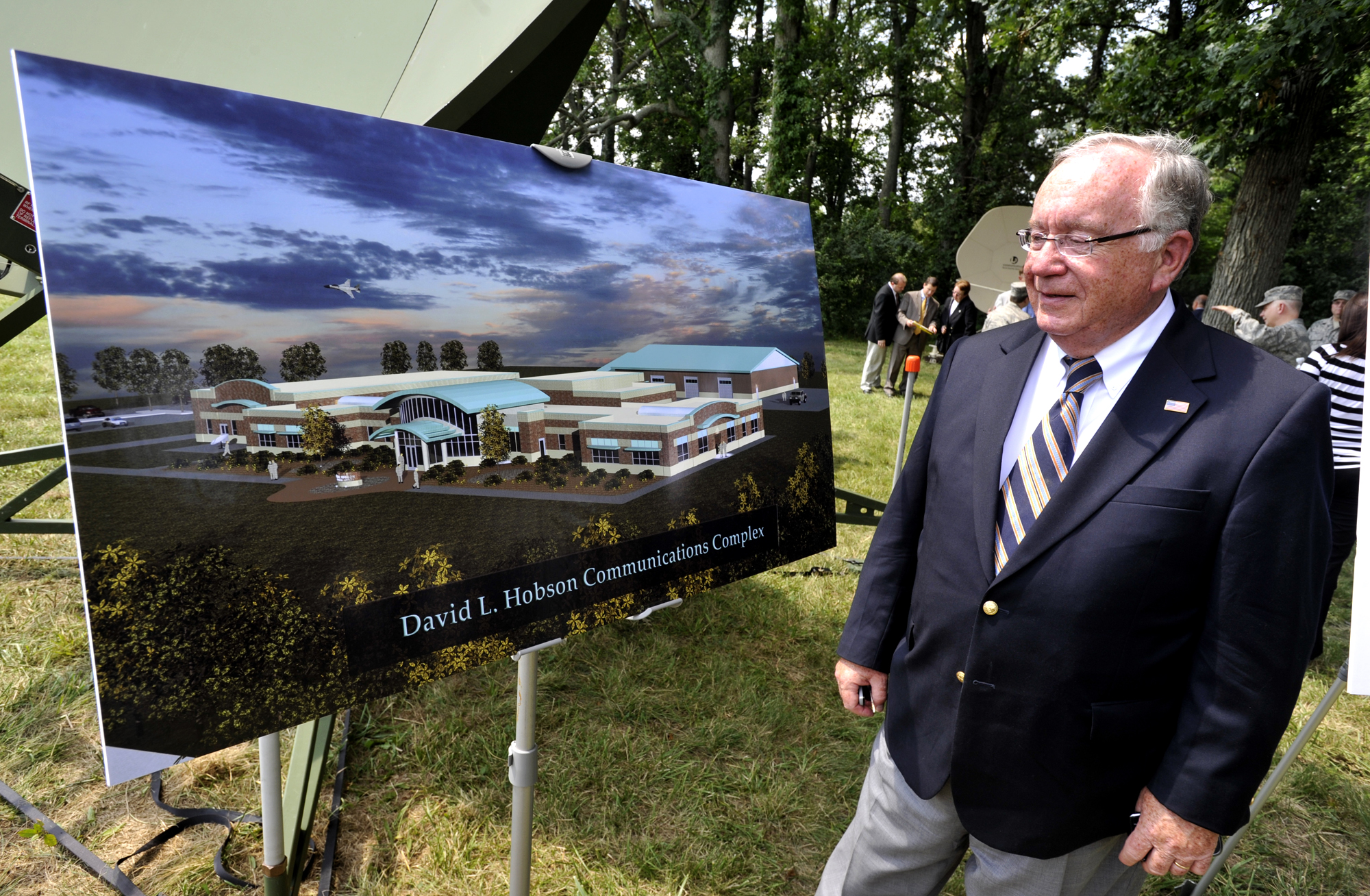 Former U.S. Rep. David Hobson looks over the artist rendering of the new David L. Hobson Communications Complex at the Springfield Air National Guard Base Friday during the ground-breaking ceremony for the complex. Hobson was instrumental in securing the funding for the project. Staff photo by Bill Lackey