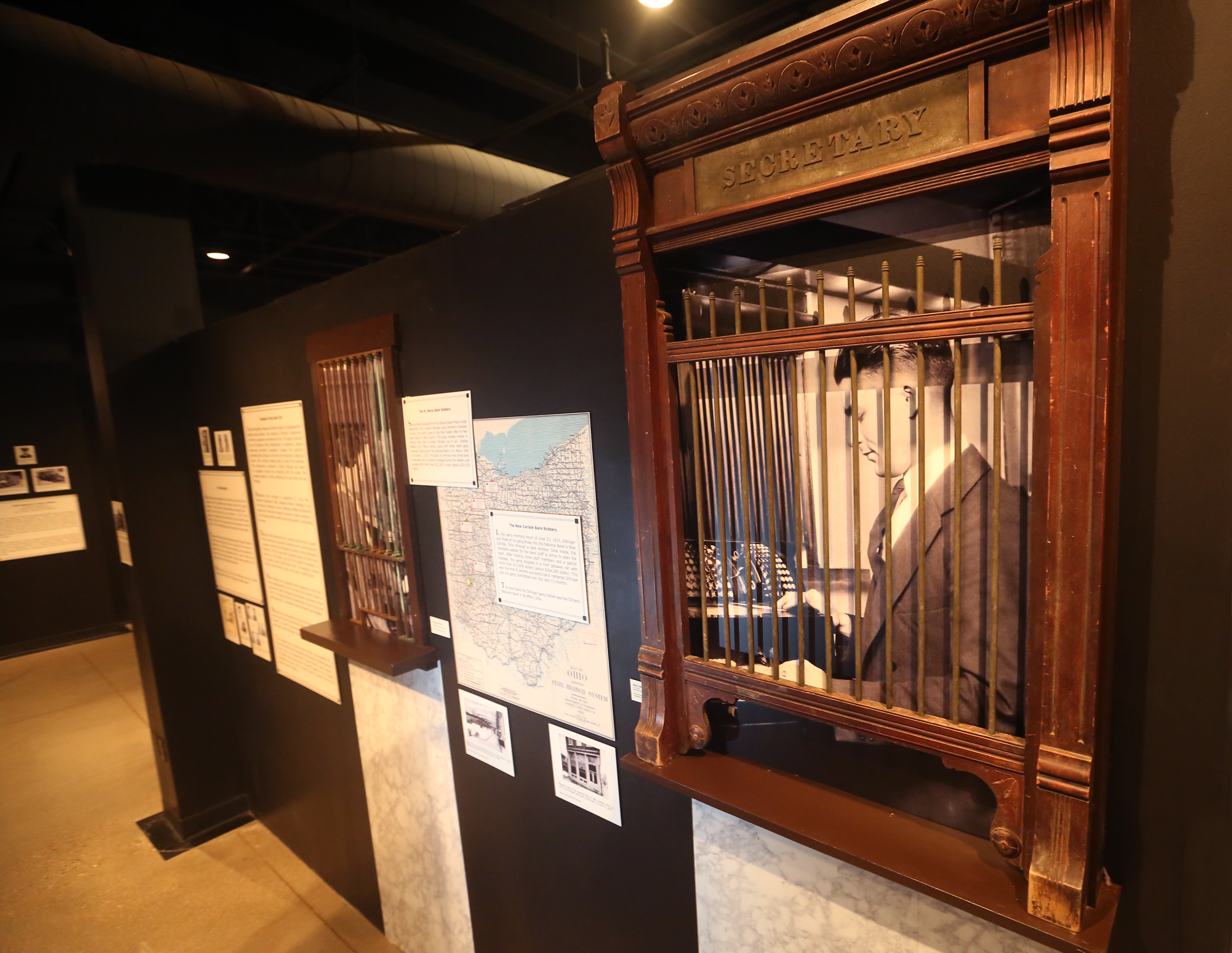 A wooden bank tellers window from the National Bank in New Carlisle that John Dillinger and his gang robbed in 1933 is a tangible piece of history in the Bootleggers, Bandits, and Badges: From Dry Times to Hard Times in Dayton, Ohio, exhibition at Carillon Historical Park. LISA POWELL / STAFF