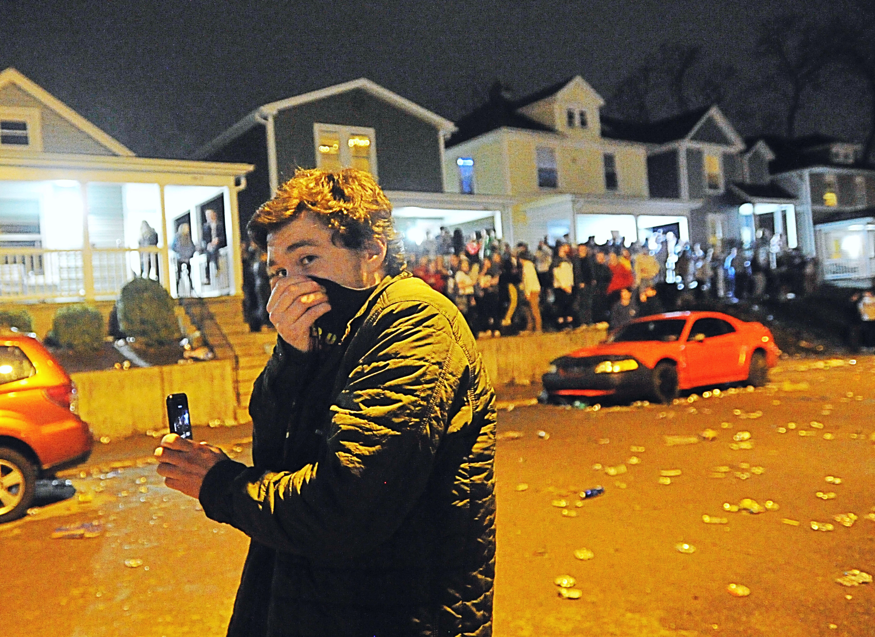 Police respond to the University of Dayton campus on Lowes Street on a report of a large crowd. UD says more than 1,000 students gathered on Lowes Street in the South Student Neighborhood Tuesday night in reaction to housing closing Wednesday, March 11, 2020 for most students due to the spread of the coronavirus. Police launched pepper balls, which contain powder with an irritant that disperses quickly, that were unsuccessful in reducing the crowd size Officials say at least one person was reportedly injured by a thrown bottle. Staff photo by Marshall Gorby.