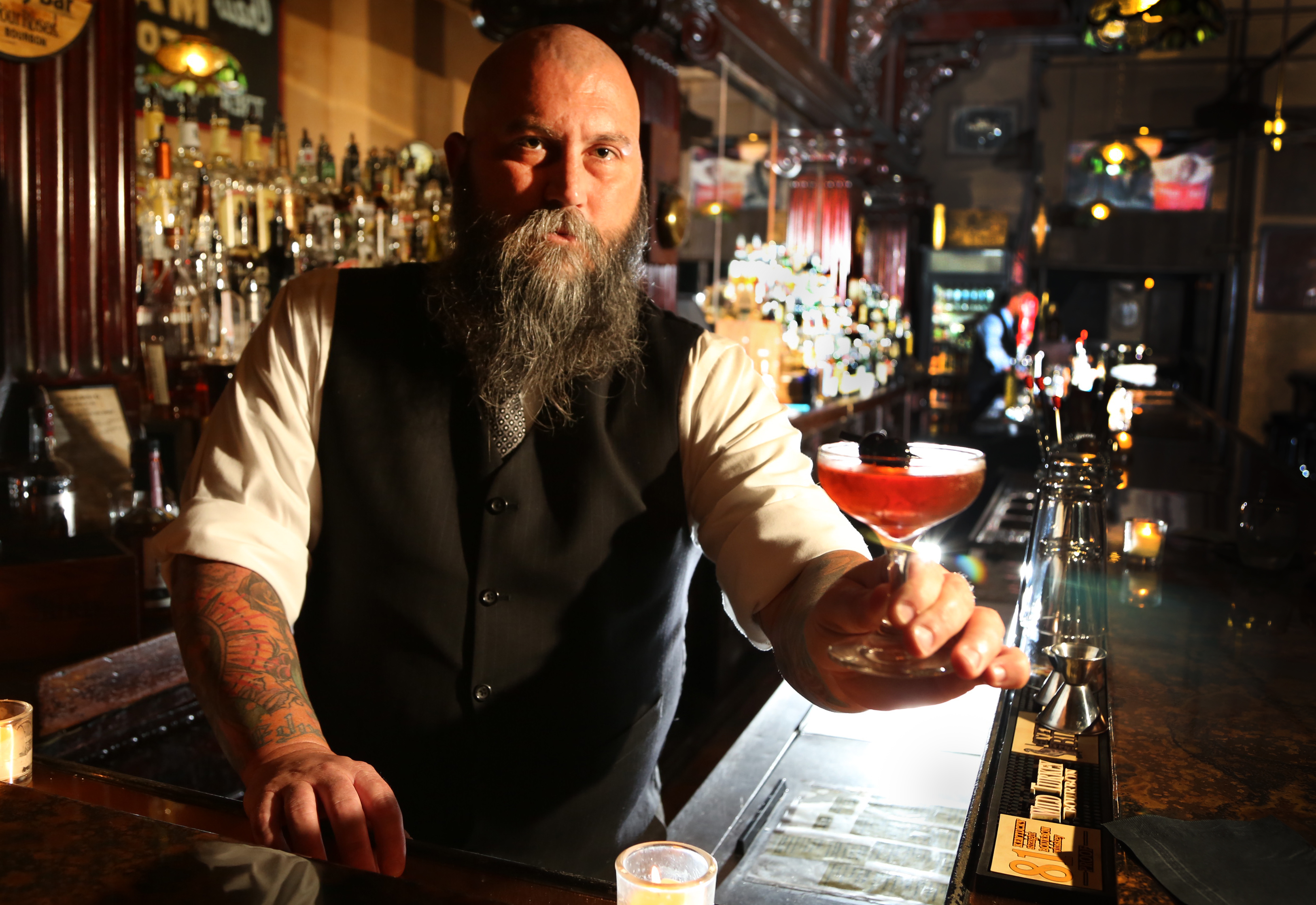 Co-owner Joseph Head with the Summer Cocktail " Remember the Maine" made with Rye Whiskey, Cherry Liquer, Bitters, Bulliet Rye and Sweet Vermouth at the Century Bar, 10 S Jefferson St, Dayton. JIM WITMER/STAFF
