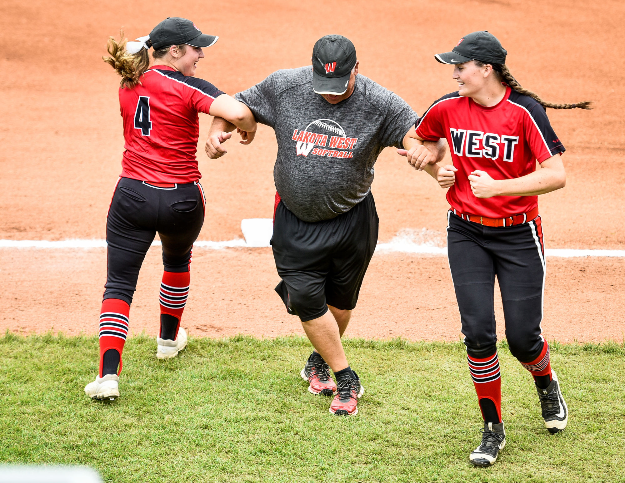 Lakota West coach Keith Castner has some pregame fun with Corey Weaver (4) and Cameron Wesley prior to Saturday’s Division I state final against Massillon Perry at Firestone Stadium in Akron. NICK GRAHAM/STAFF