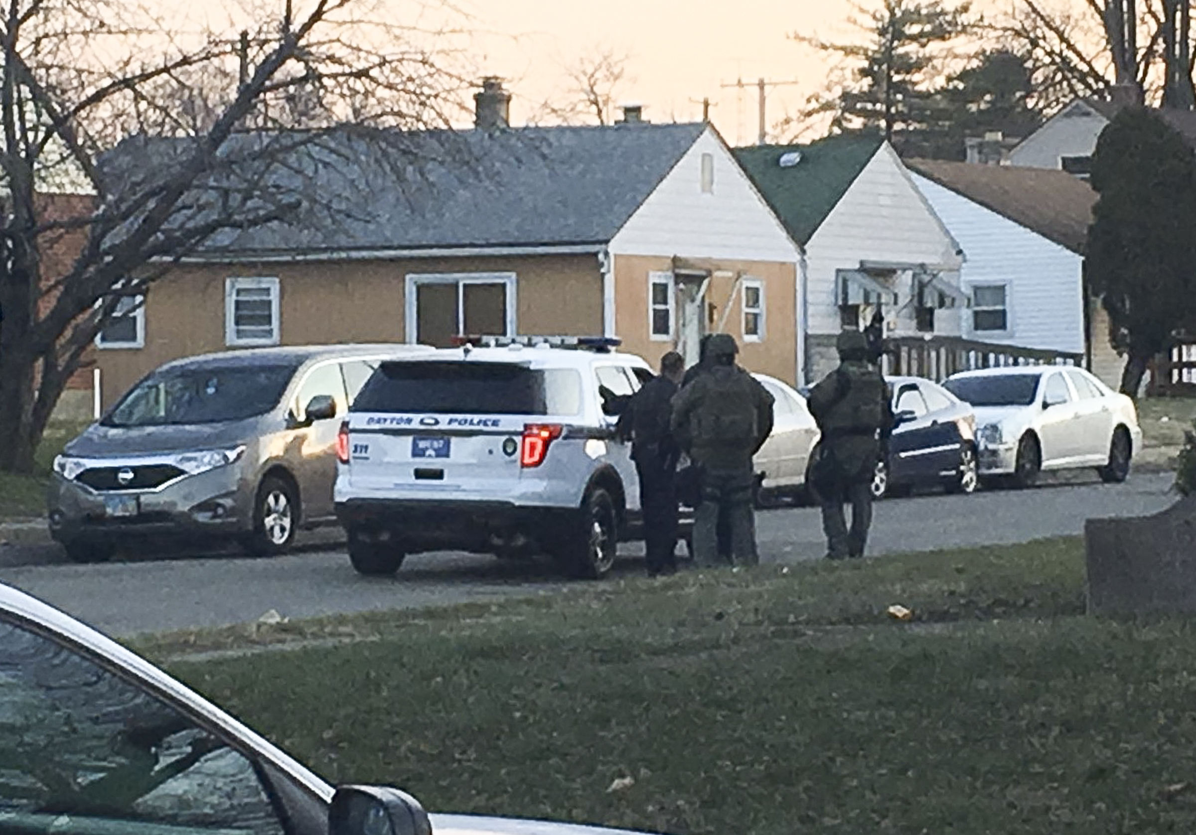 Dayton police surround a house in the 1400 block of Tampa Avenue on Saturday morning after a suspect in a fatal shooting was believed barricaded inside, according to authorities. The man police were looking for was not in the house. JEFFERY BROWN / STAFF