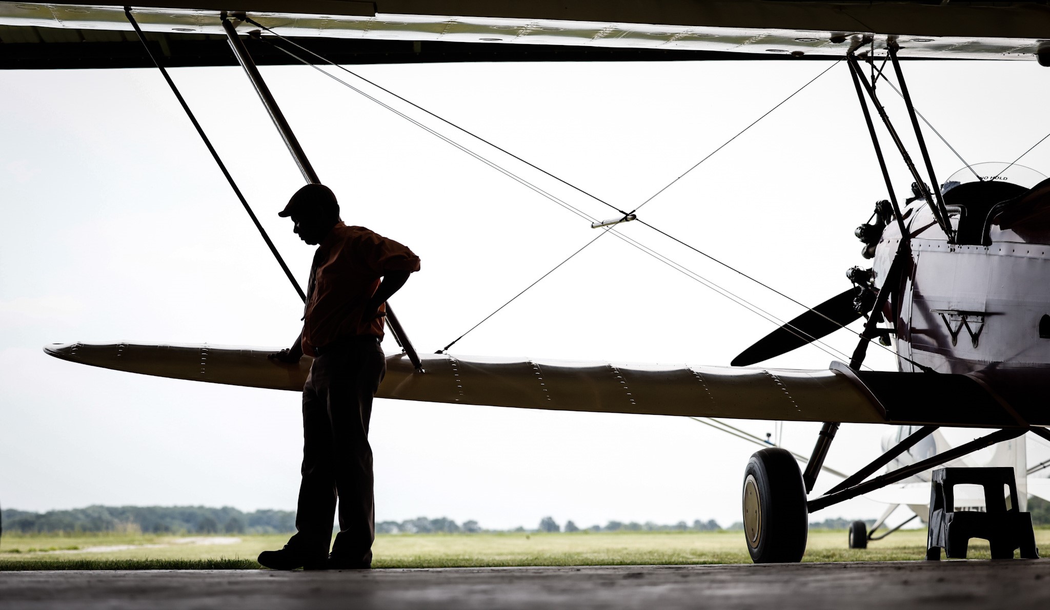 Dewey Davenport stands near one of his 1930s vintage biplanes in his hanger near Jamestown. .Davenport says he is a “true barnstormer,” because he travels from town to town to give plane rides, just like the barnstormers did in the early 20th century. JIM NOELKER/STAFF