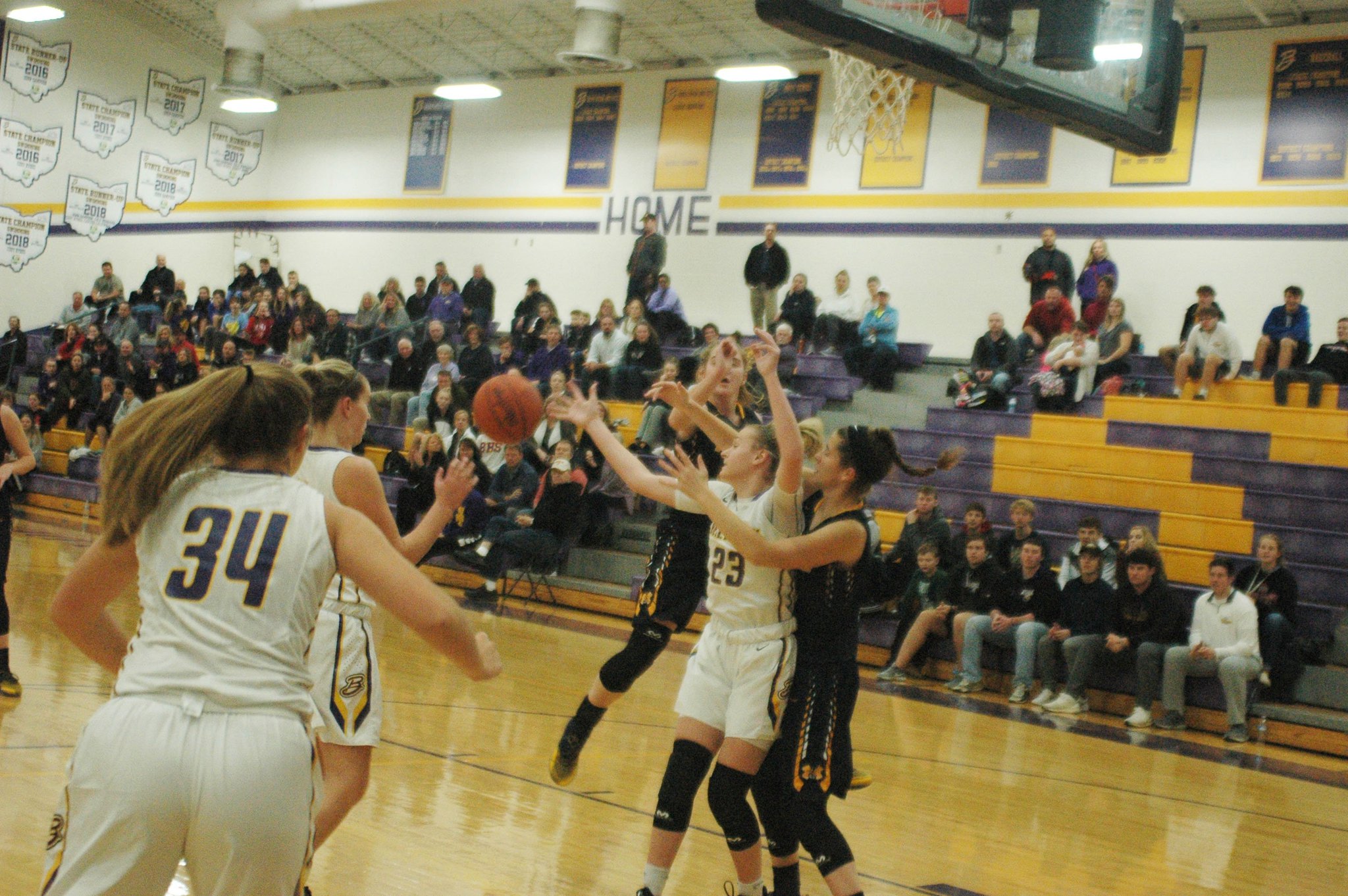 Monroe’s Alyssa Beckett gets her arms around Bellbrook’s Bailey Zerby (34) on a rebound attempt Monday night at Bellbrook. Monroe earned a 31-29 victory. RICK CASSANO/STAFF