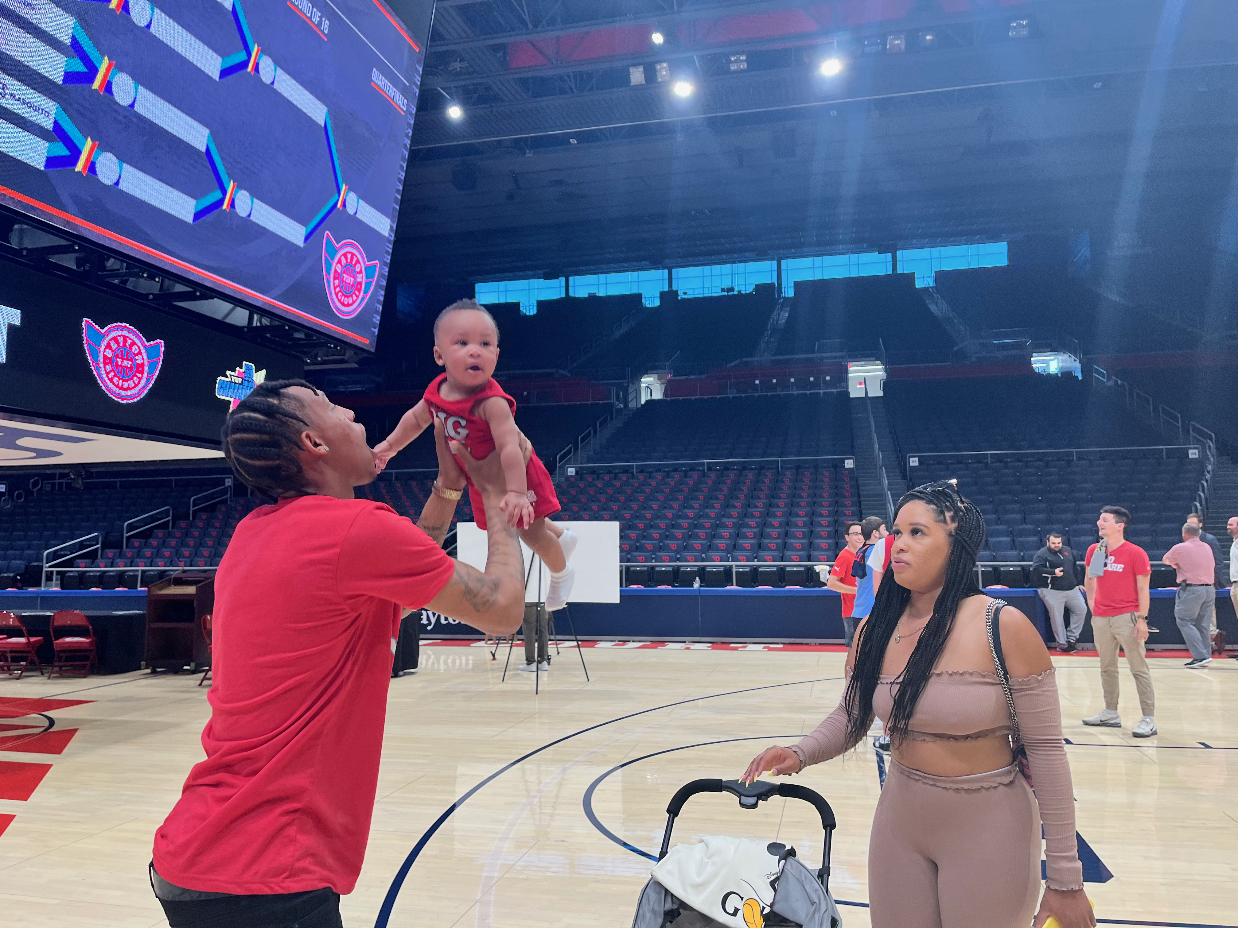 The Red Scare's Joe Thomasson holds his son Jesiah (7 months) as his fiancée, LaDreshay, watches after a press conference for The Basketball Tournament on Wednesday, June 22, 2022, at UD Arena in Dayton. David Jablonski/Staff