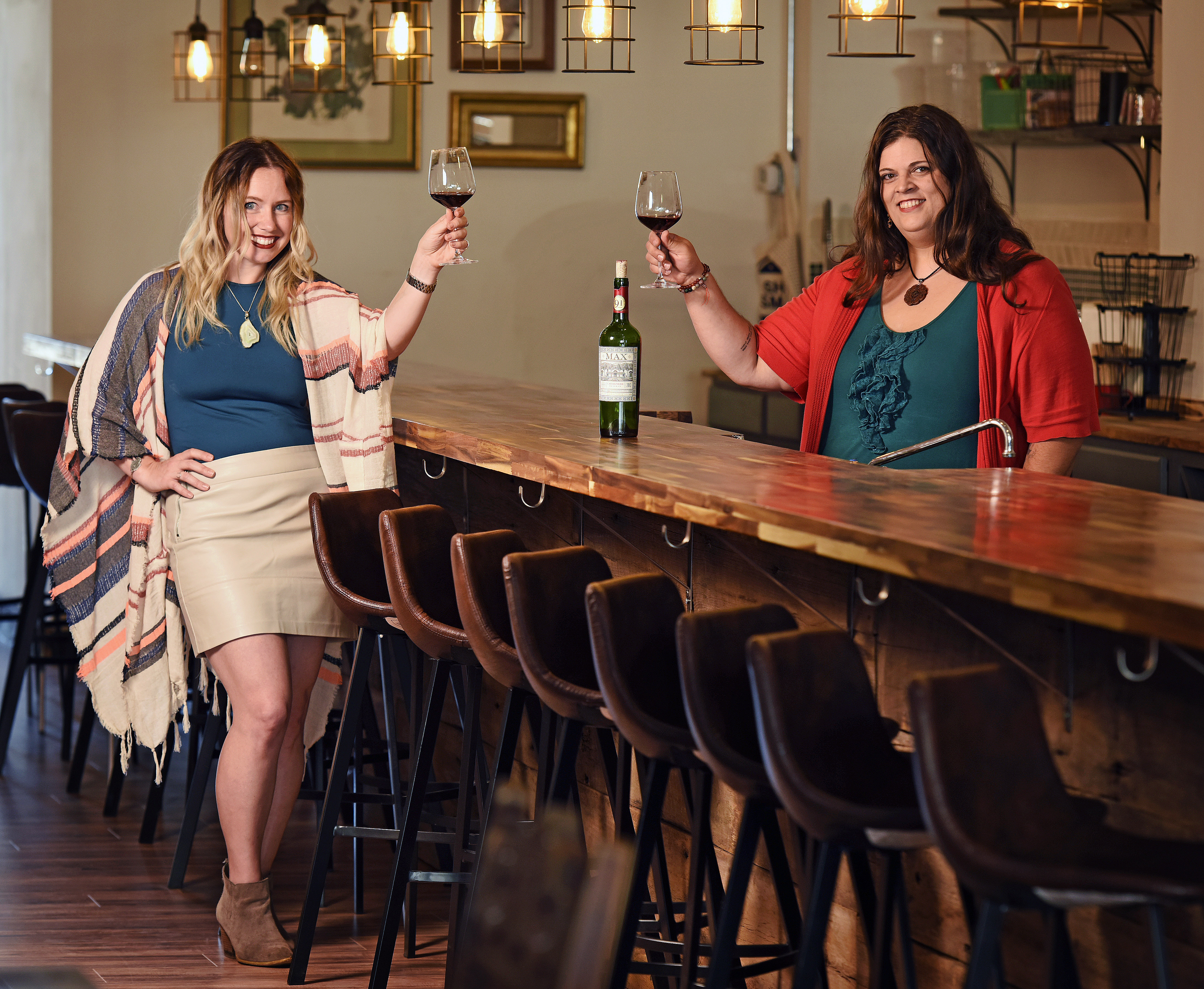 West Central Wine co-owners Monica Nenni, left, and Melissa Kutzera tracked down the daughter of a man who wrote then hid a note in the basement of their business nearly 60 years ago.
