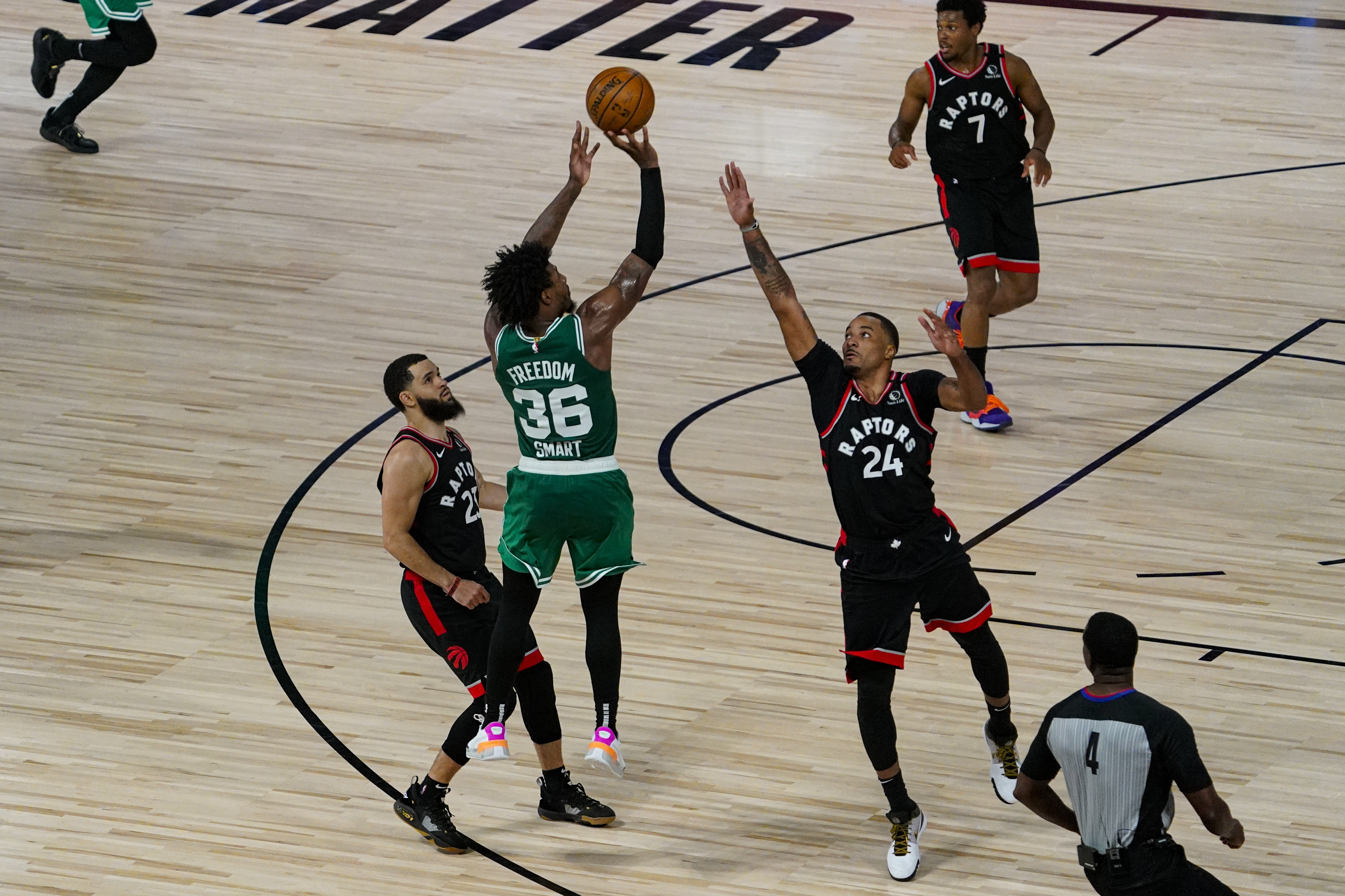 Boston Celtics guard Marcus Smart (36 misses a shot over over Toronto Raptors guard Norman Powell (24) with less a second remaining in the second overtime an NBA conference semifinal playoff basketball game Wednesday, Sept. 9, 2020, in Lake Buena Vista, Fla. (AP Photo/Mark J. Terrill)