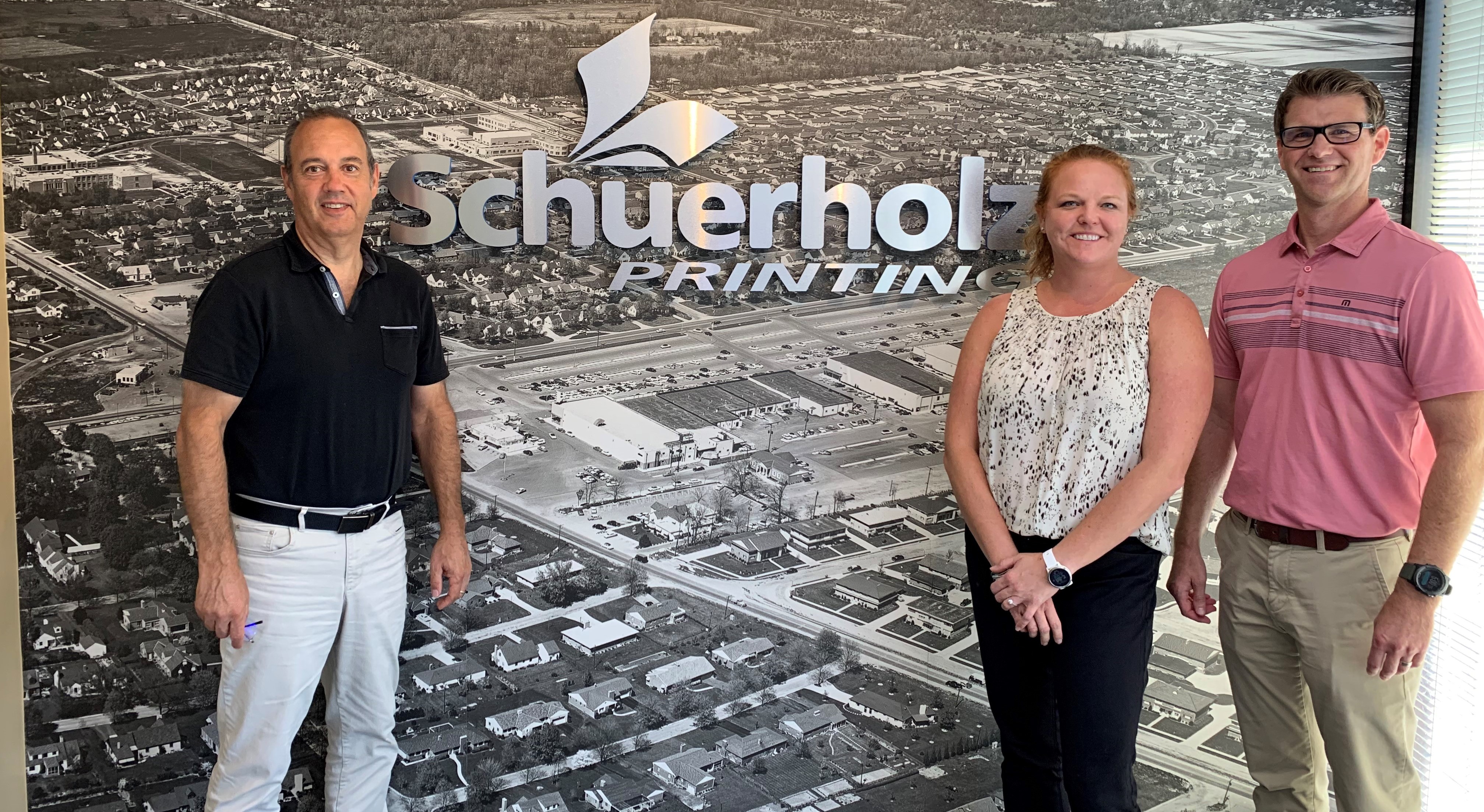 Charley Schuerholz (left) sells Schuerholz Printing to Nikki and Brandon Jasper (right).contributed