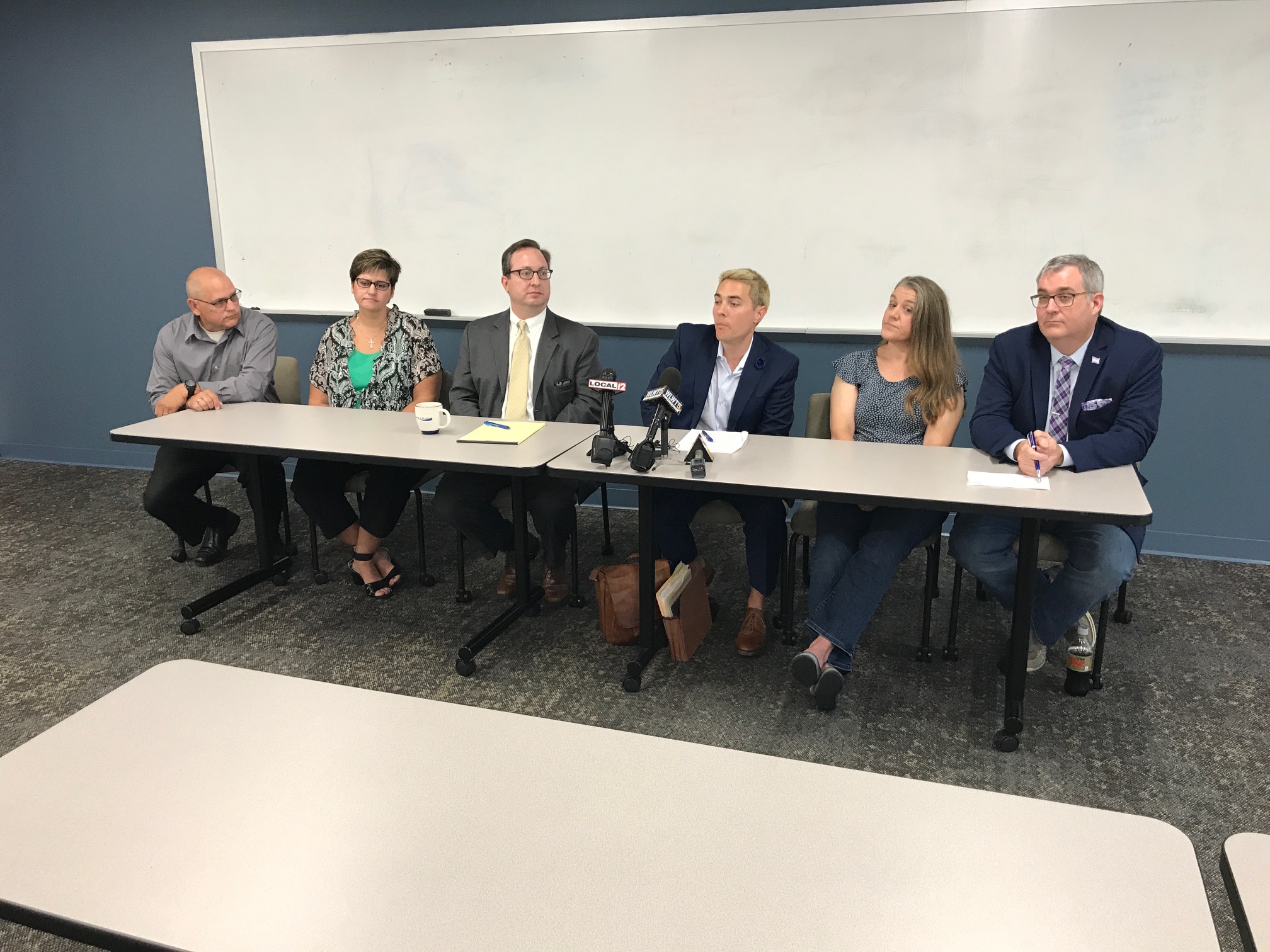 The parents of two Warren County transgender teens, with their attorneys Josh Engel and Josh Langdon (center) discuss a federal lawsuit they have filed against Warren County Juvenile and Probate Judge Joseph Kirby on Friday, Aug. 3. They want the federal court to force Kirby to grant a name change for their children who were born female but identify themselves as male.
