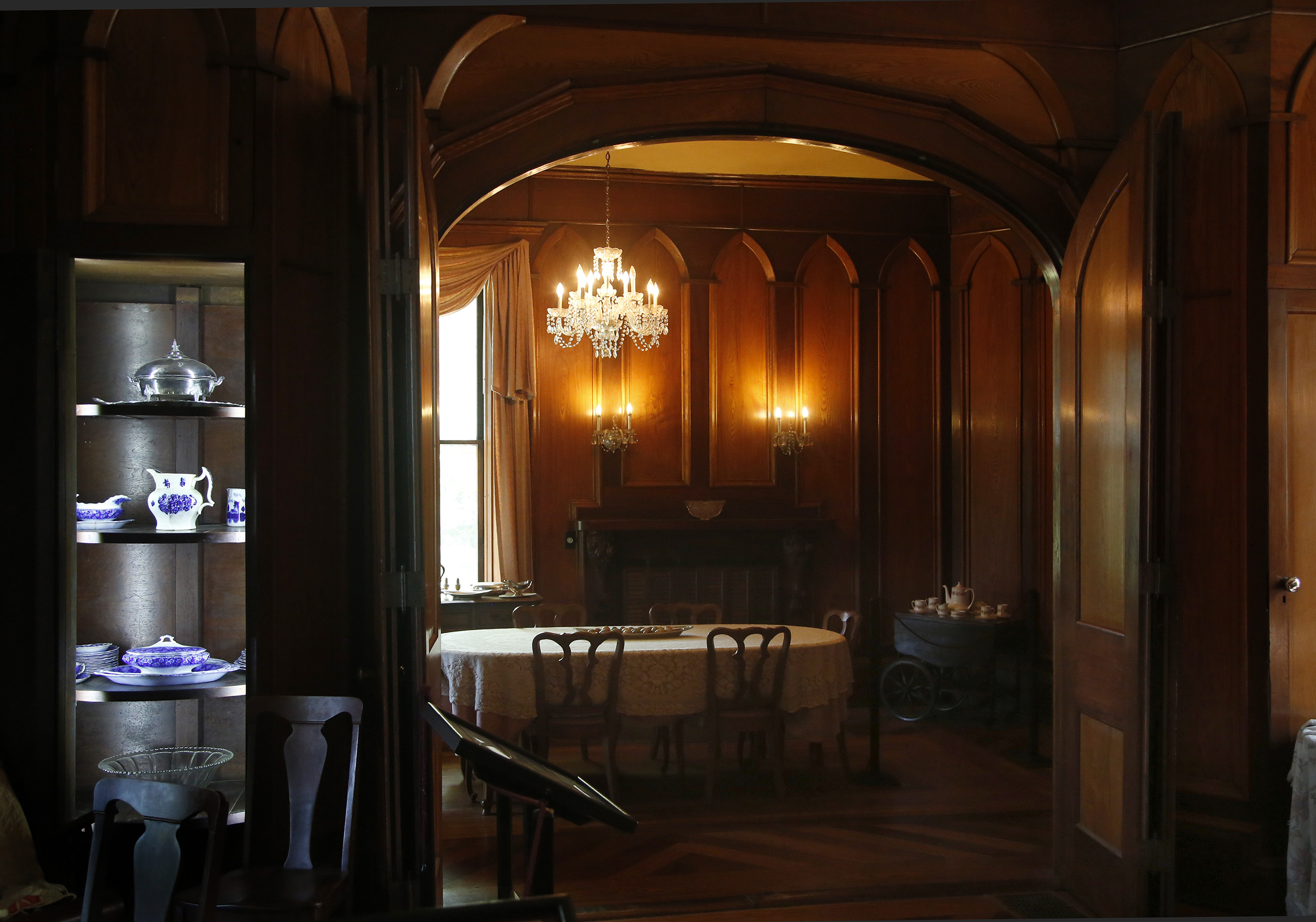 A chandelier illuminates the oak and walnut raised panels surrounding the dining room and parquet floors shine at Mac-A-Cheek, a home built by Abram Sanders Piatt and one of the Piatt Castles of Logan County. LISA POWELL / STAFF