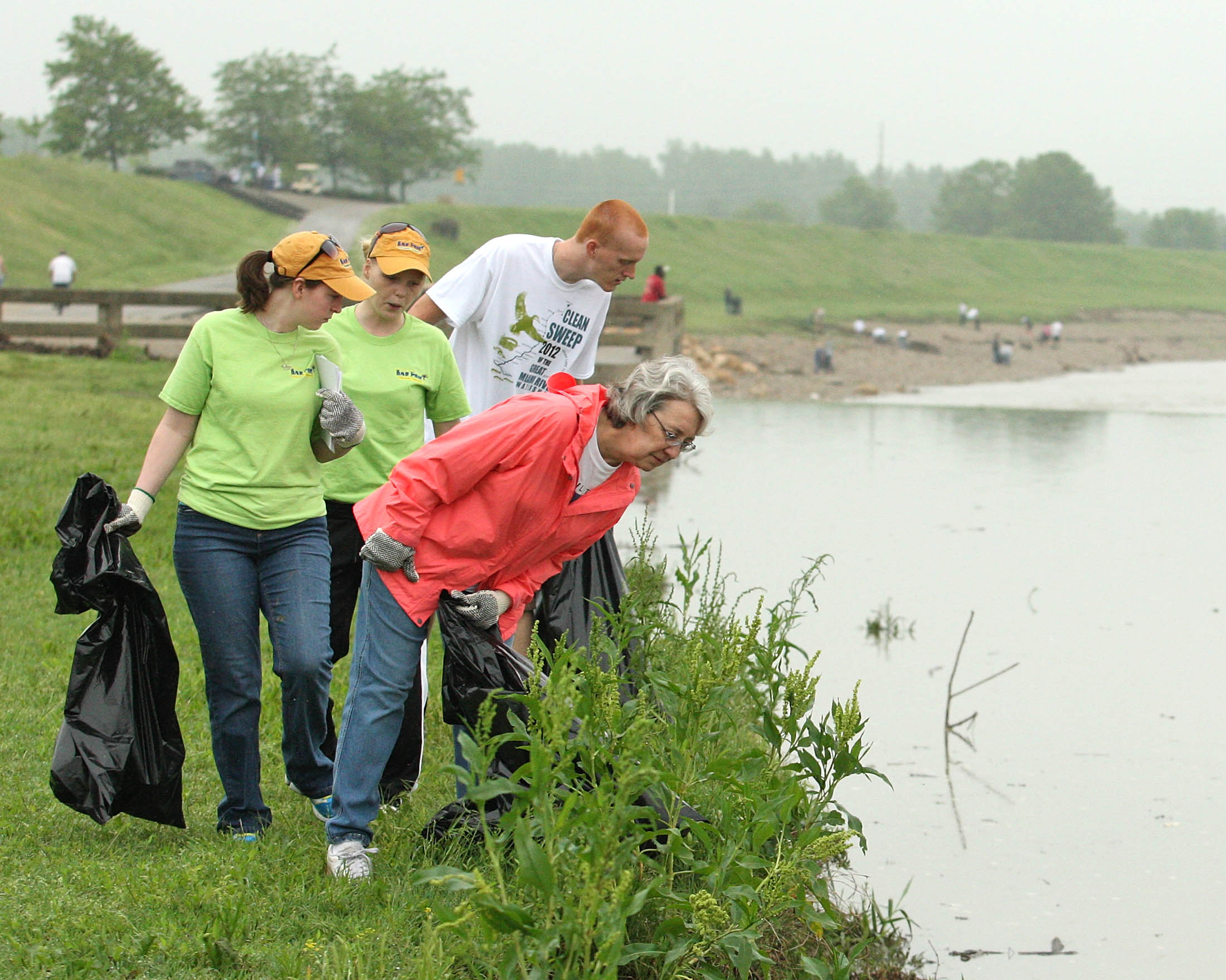 Volunteers Haley Dickinson and Kasey Banks of Bad Frog Frozen Yogurt and Jeff Gambrell and Louise Jewett look for littered trash while participating in the Clean Sweep of the Great Miami River, Saturday, May 5, 2012, in Hamilton. Photo by Robert Leifheit/Contributing Photographer