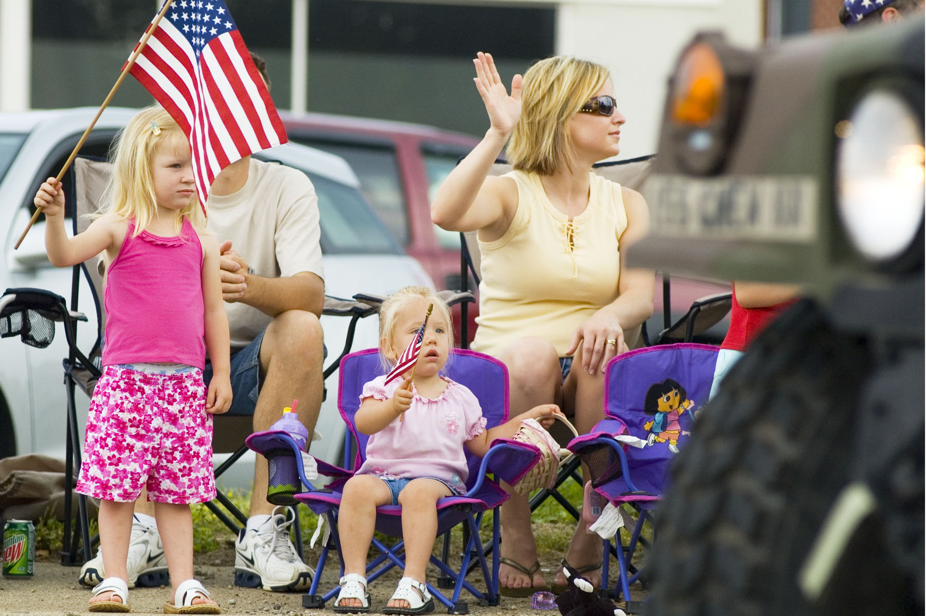 Alyssa McGuire, 3, and Acasia McGuire, 2, wave their American Flags as some military vehicles drive by during the Memorial Day parade Monday morning in Middletown. Behind the children are Kevin and Jamie McGuire.
NICHOLAS S. GRAHAM