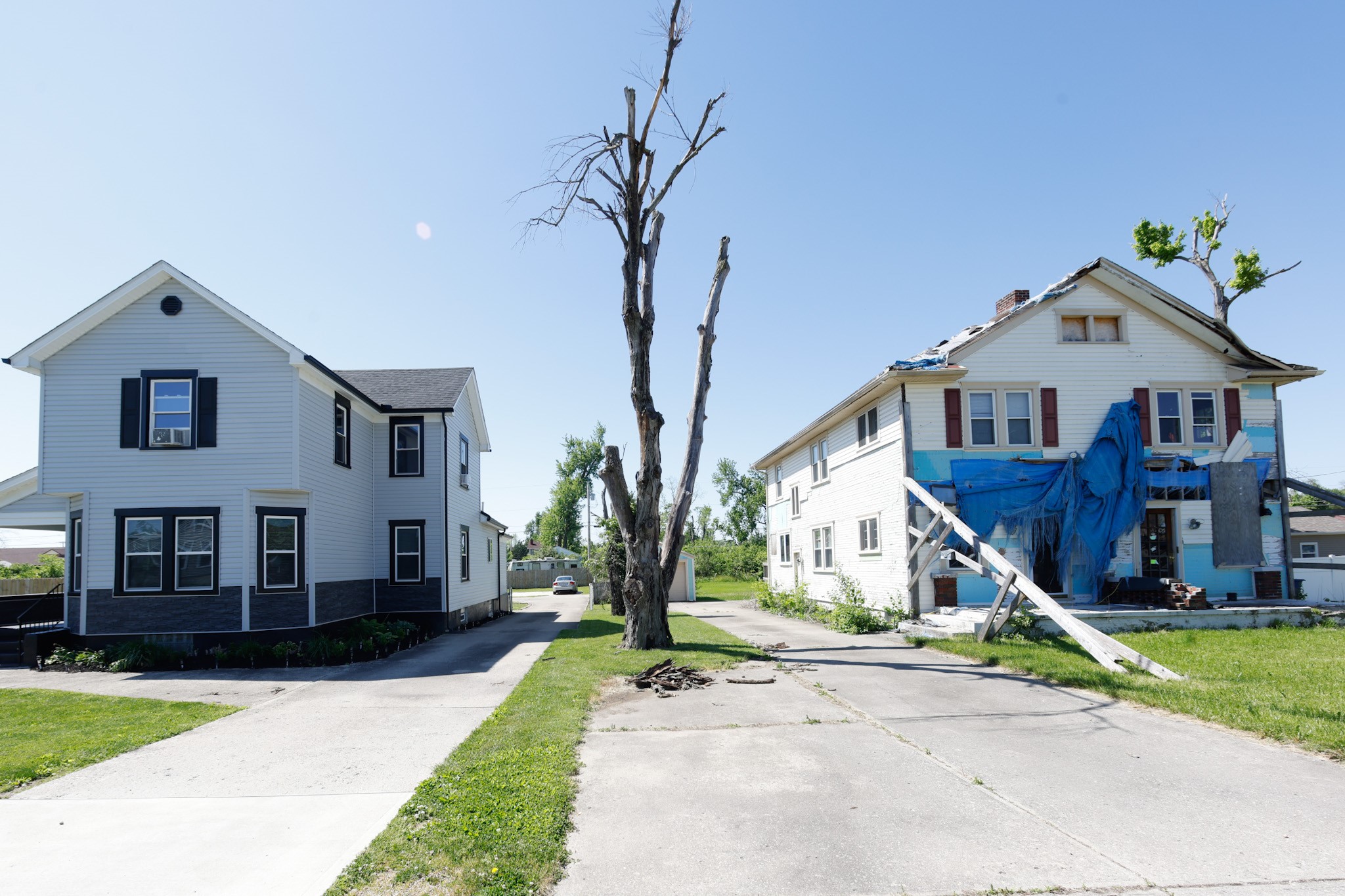Three years after the 2019 Memorial Day tornadoes, two houses on Hillsdale Avenue, on the Dayton-Harrison Twp. border, show the range of success and struggle in the recovery process. JIM NOELKER/STAFF