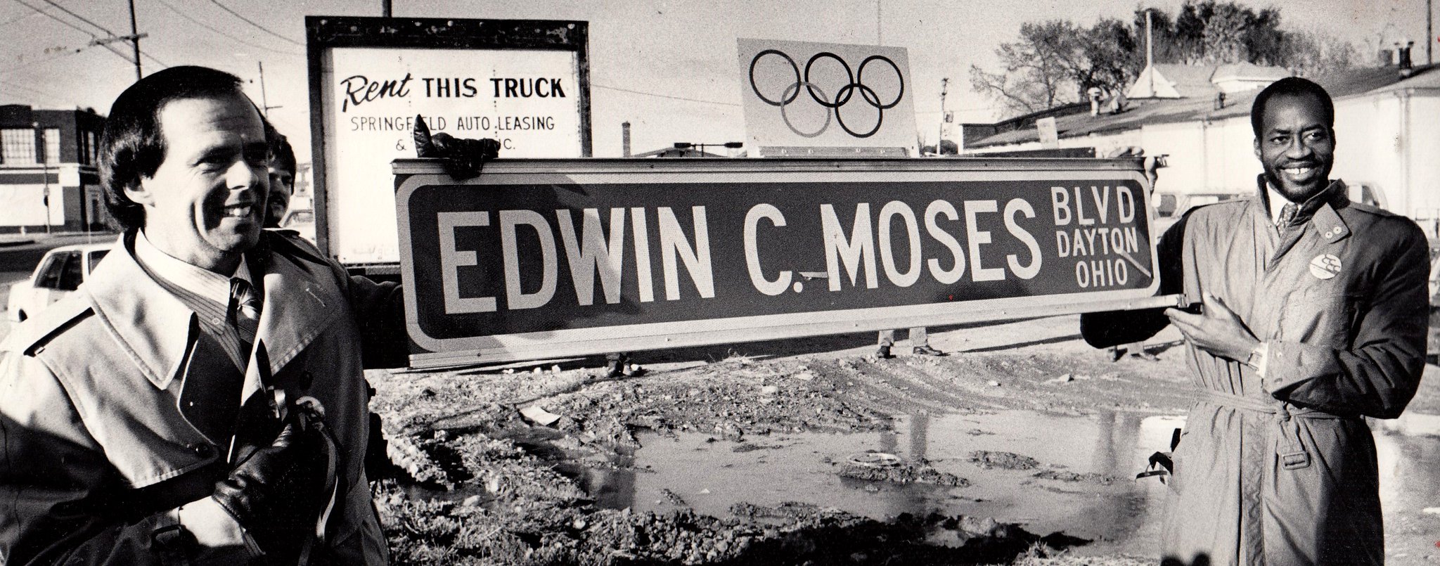 Mayor Paul Leonard (left) and Edwin Moses hold Edwin S. Moses Boulevard.  road sign for photographers during the ceremony of renaming the street in honor of the 1984 Olympic champion.  DAYTON DAILY NEWS ARCHIVE