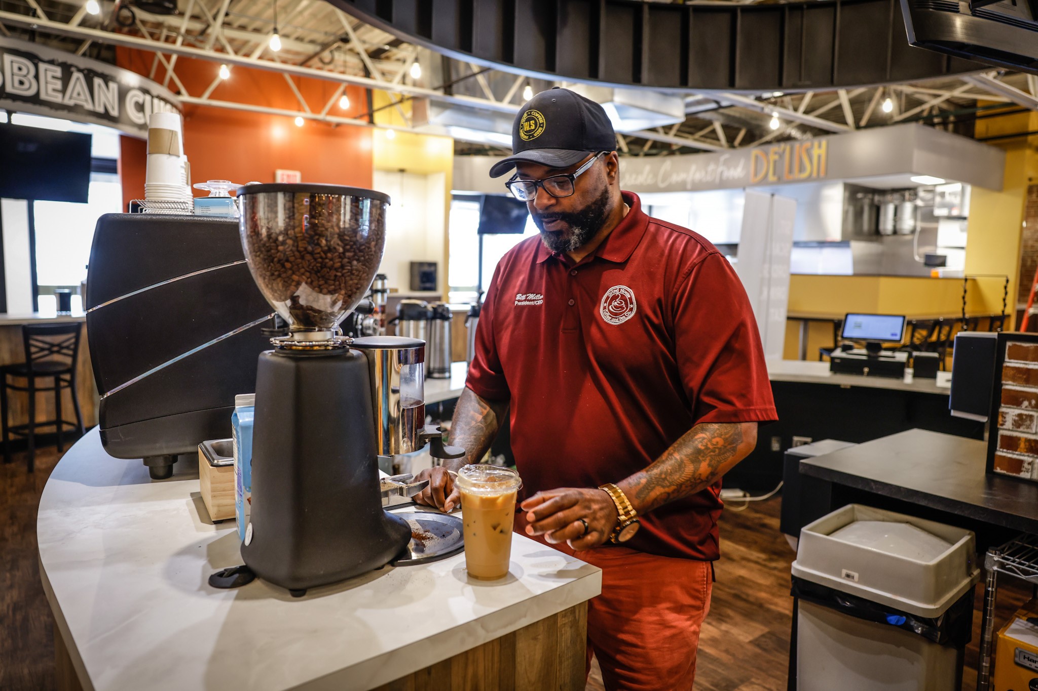 Bill Miller, owner of Grind House Coffee Co. makes a tall iced coffee. The Grind House Coffee Co. is one of six local restaurants that make their home at West Social Tap and Table which will open July 25, 2022. JIM NOELKER.STAFF