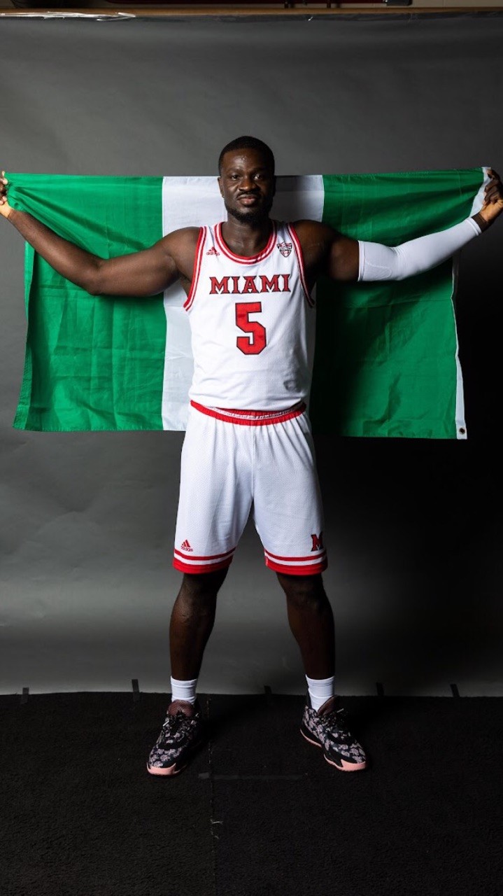 Miami's Precious Ayah with the Nigerian flag. He grew up in Yenogoa, Nigeria and came to the United States when he was 14 thanks to the Ejike Ugboaja Foundation started by the famed Nigerian basketball player who was drafted by the Cleveland Cavs in 2006 – the only NBA player drafted straight out of Africa—and had a long career with the national team and as a pro for 14 seasons overseas. (Contributed Photo)