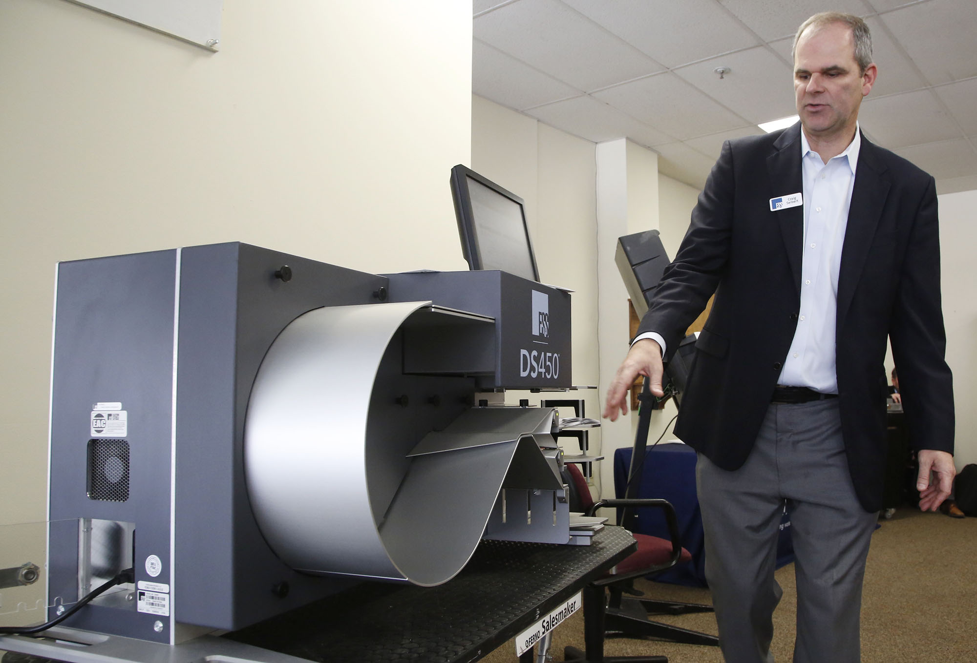 Craig Seibert, regional sales manager, from Election Systems & Software demonstrates a voting machine to the Greene County Board of Elections in Xenia. Dominion Voting Systems machines were demonstrated in a later session. TY GREENLEES / STAFF