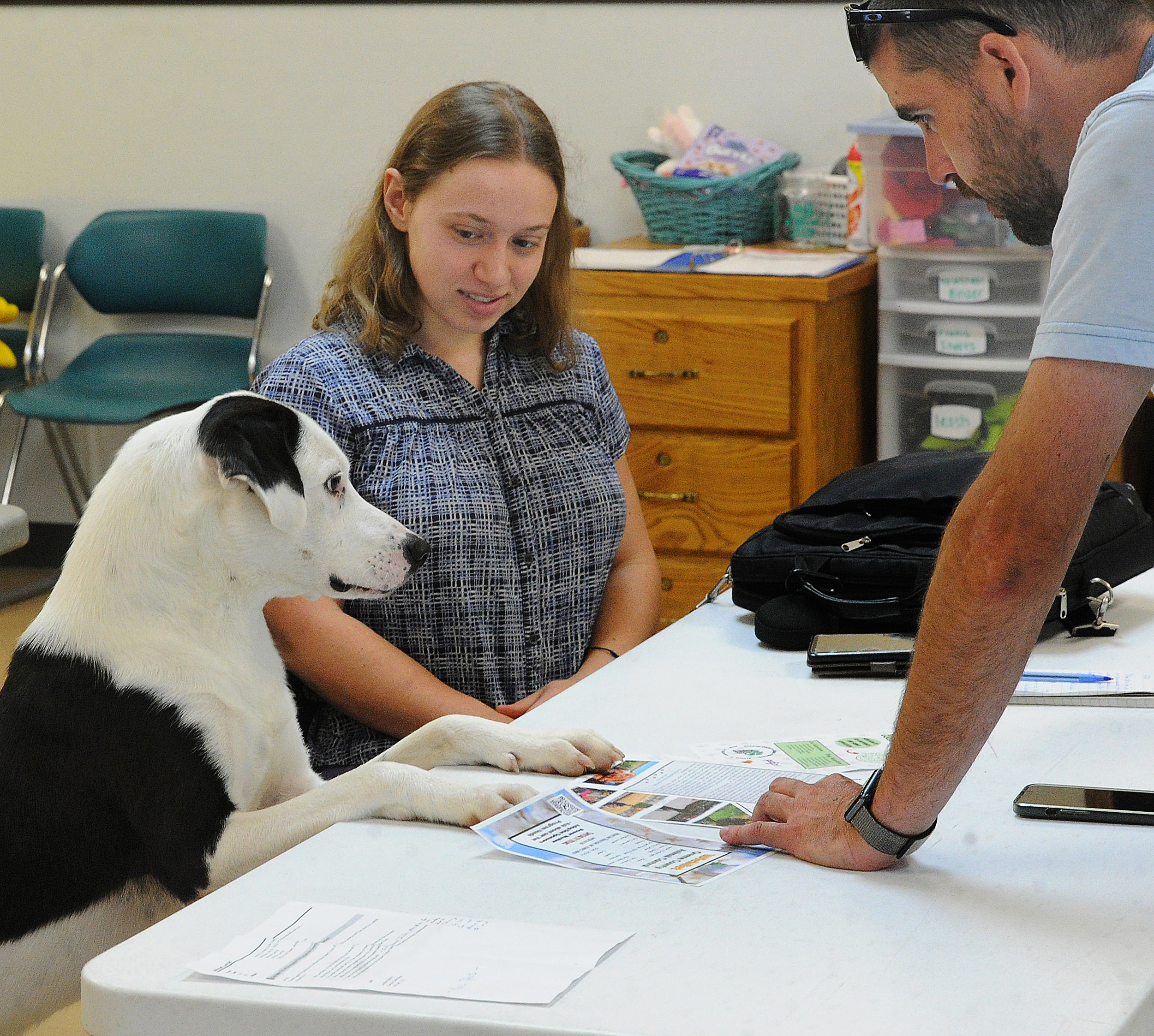 Butch (left) has important things to say to Dayton Daily News reporter London Bishop (center) and Jarrod Mitchell of Greene County Animal Control (right) about his next adoption field trip.  MARSHALL GORBYSTAFF