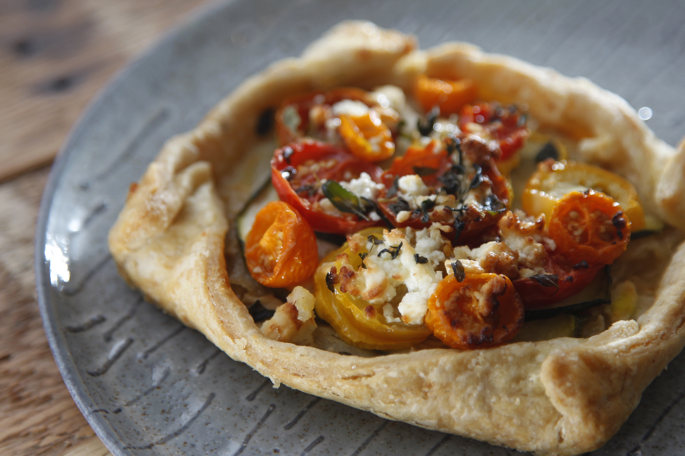 A zucchini, tomato and feta tart from St. Anne the Tart, a new bakery and coffee house in Dayton's St. Anne's Hill historic neighborhood. LISA POWELL / STAFF