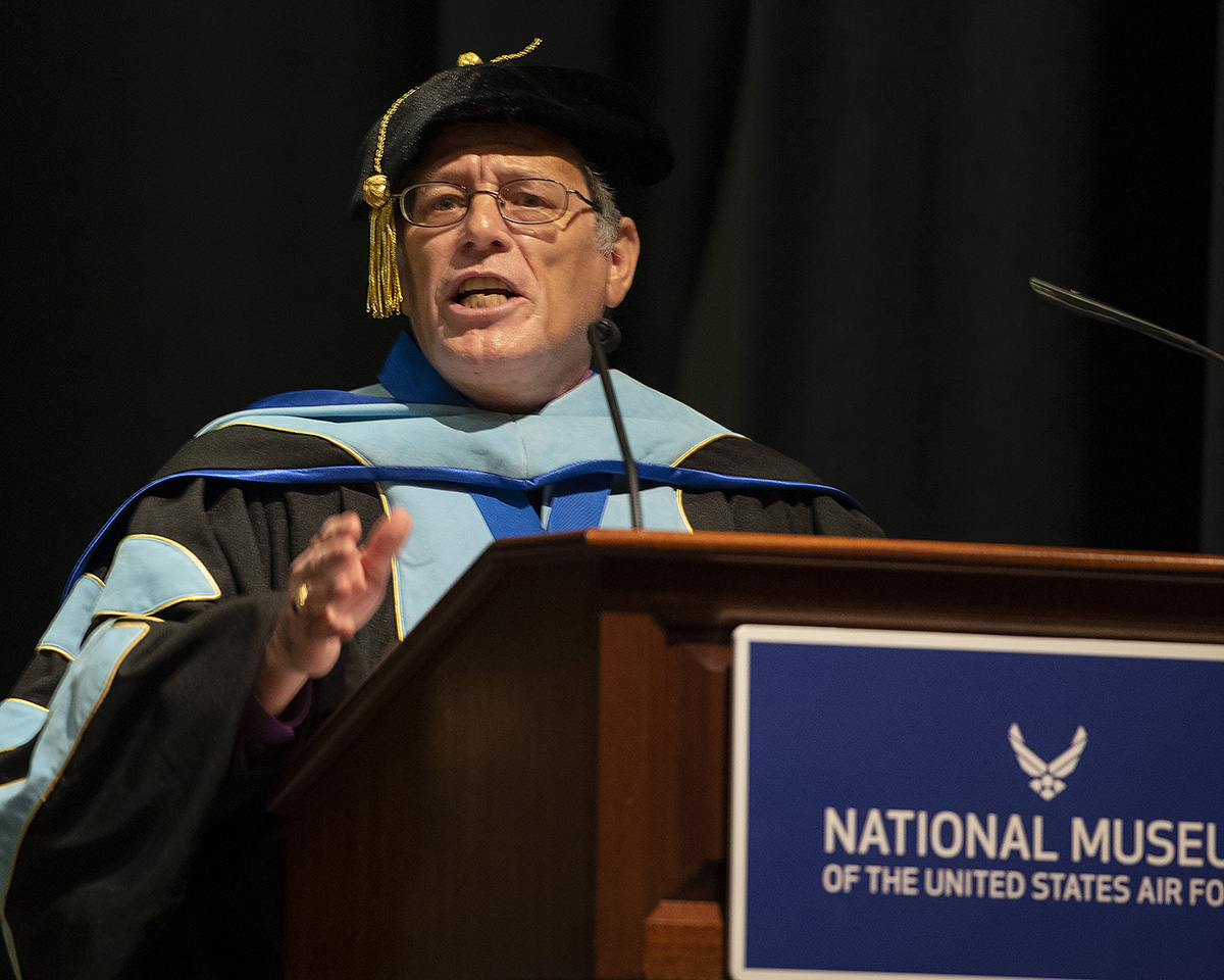 Donald Ellwood, Community College of the Air Force Education Services director, officially confers the degrees on the 40 Airmen graduating in the CCAF Wright-Patterson Spring 2022 commencement ceremony June 15 at the National Museum of the Air Force. U.S. AIR FORCE PHOTO/R.J. ORIEZ