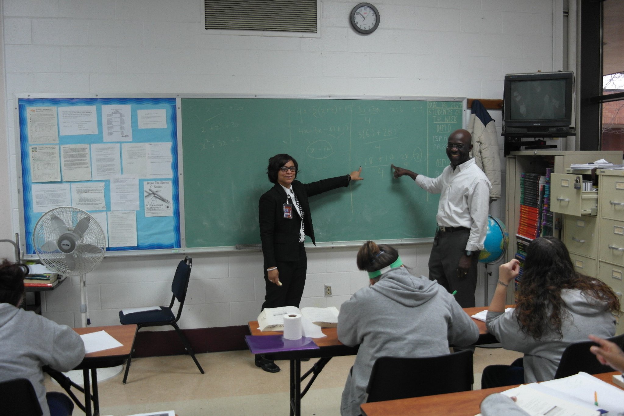 Victoria Jones,Sinclair women’s basketball coach and the site supervisor of the Sinclair education program at Dayton Correctional Institution. with math professor Kunle Akerele in a GED class at the prison (photo by Alan Mattingly/DCI) .
