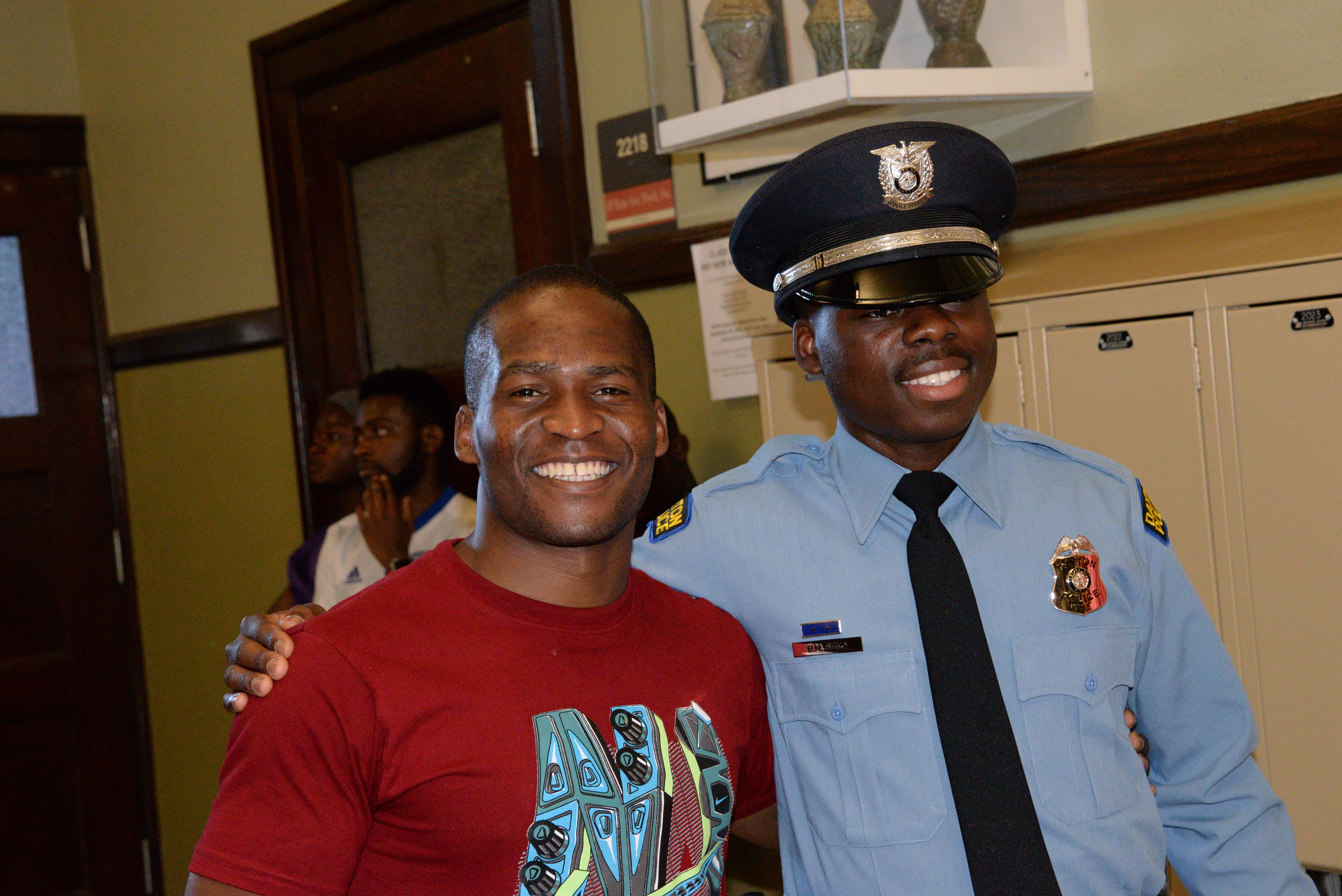 Dayton Police officers Ndayisaba Ramadhan (left) and Bibebibyo “Bibe” Seko (right) at Bibe’s graduation (Photo by Gary Laughlin)