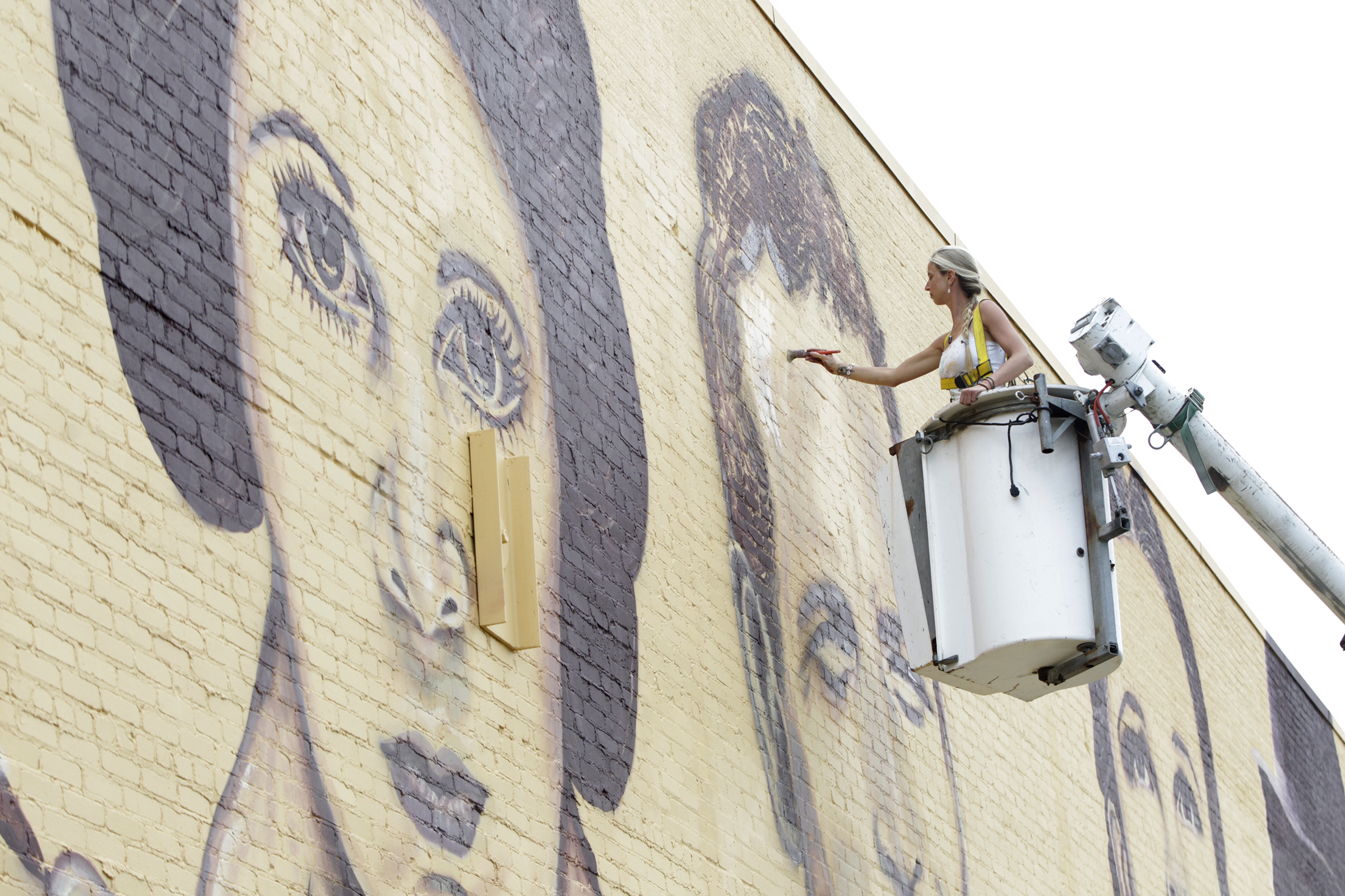 A new mural in downtown Miamisburg pays tribute to Hollywood legends. Towering portraits - 35- feet tall - of John Wayne, Carrie Fisher, Paul Newman, Judy Garland and Charlie Chaplain have been created on the north wall of the Plaza Theatre, 33 S. Main St. Artist Erica Arndts, a Centerville native, said she wanted to âpay honor to vintage Hollywood characters,â as she put the finishing touches on the 100-foot-long mural. LISA POWELL / STAFF