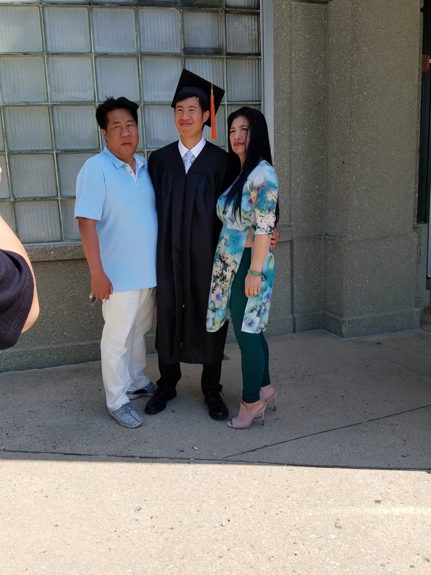 Tommy Nguyen with his parents, Lily and Tommy Sr., at his Beavercreek High graduation.  CONTRIBUTED