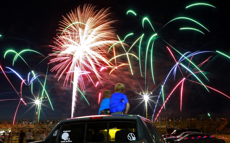 Two boys watch Clark County Fireworks display on Monday, July 1, 2019 at the Clark County Fairgrounds. BILL LACKEY/STAFF