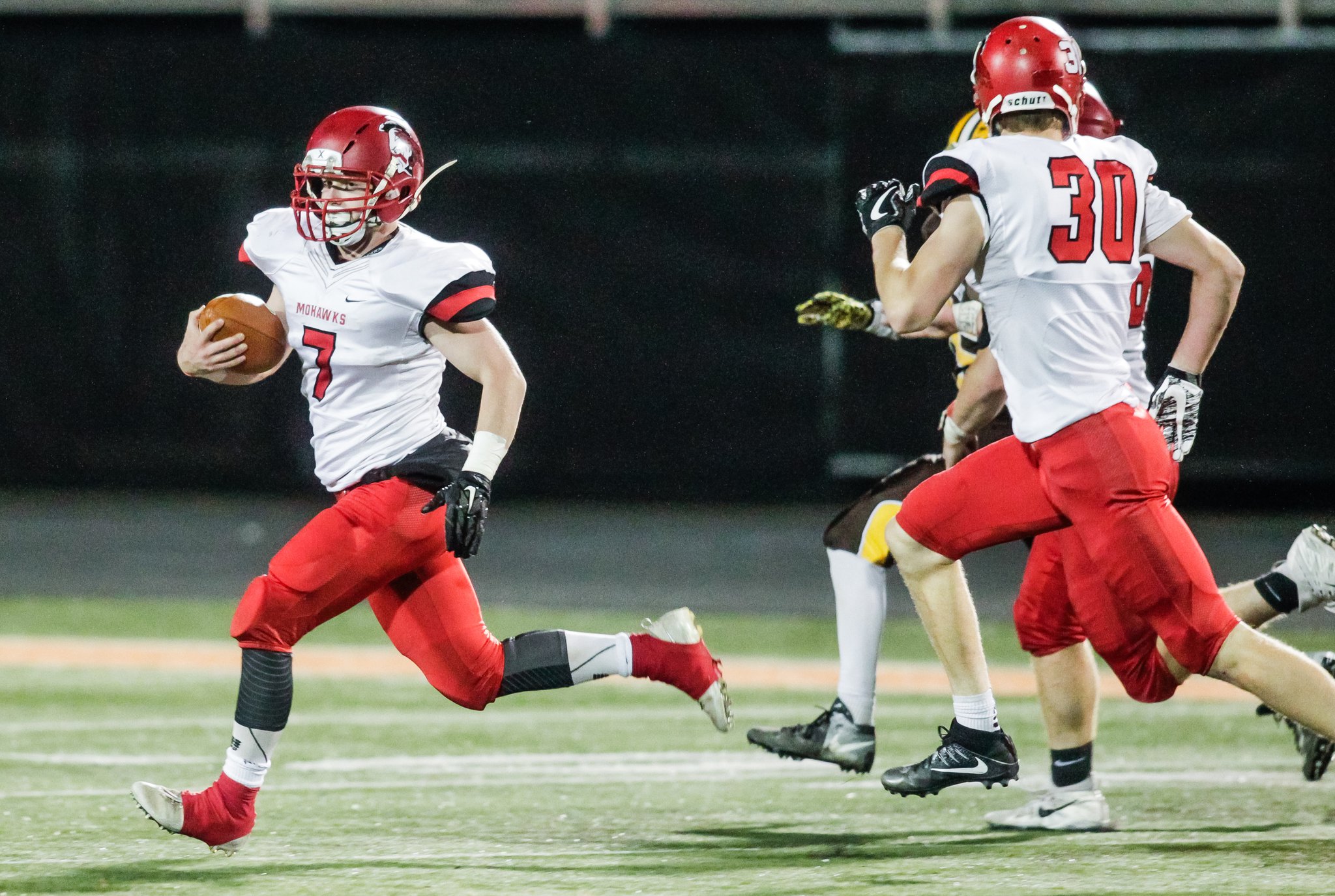 Madison’s Levi McMonigle (30) prepares to throw a block for teammate Mason Whiteman (7) during a 96-yard interception return for a touchdown against West Jefferson during the Division V, Region 20 title game Nov. 17 at Beavercreek. NICK GRAHAM/STAFF