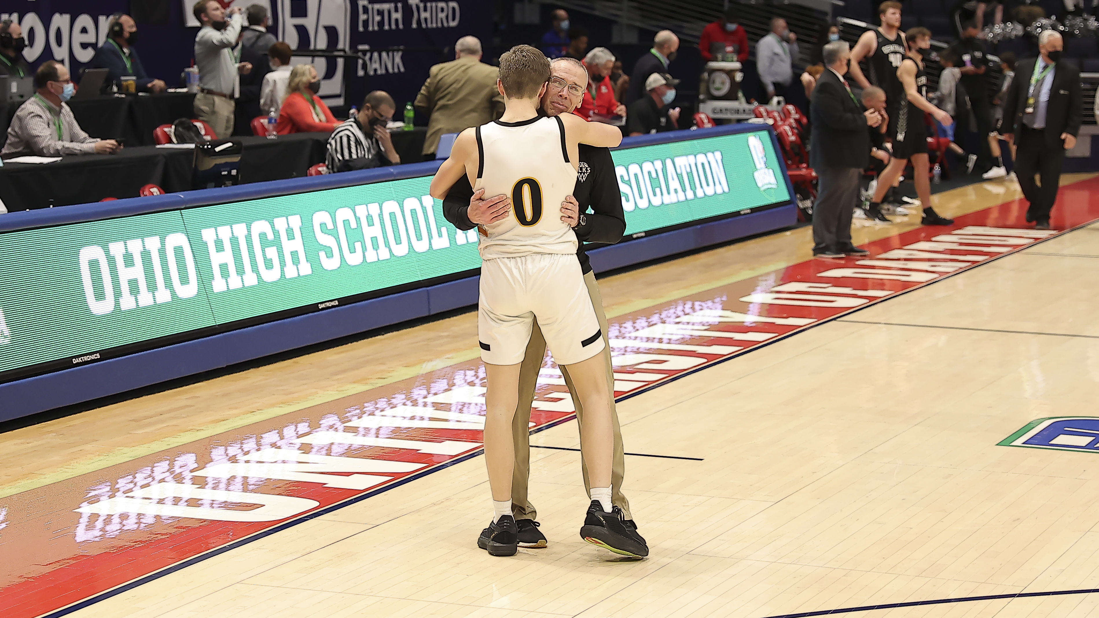Centerville boys basketball coach Brook Cupps embraces his son, Gabe, the team's sophomore point guard, after the Elks beat Westerville Central in the D-I state championship game Sunday night at UD Arena. Michael Cooper/CONTRIBUTED
