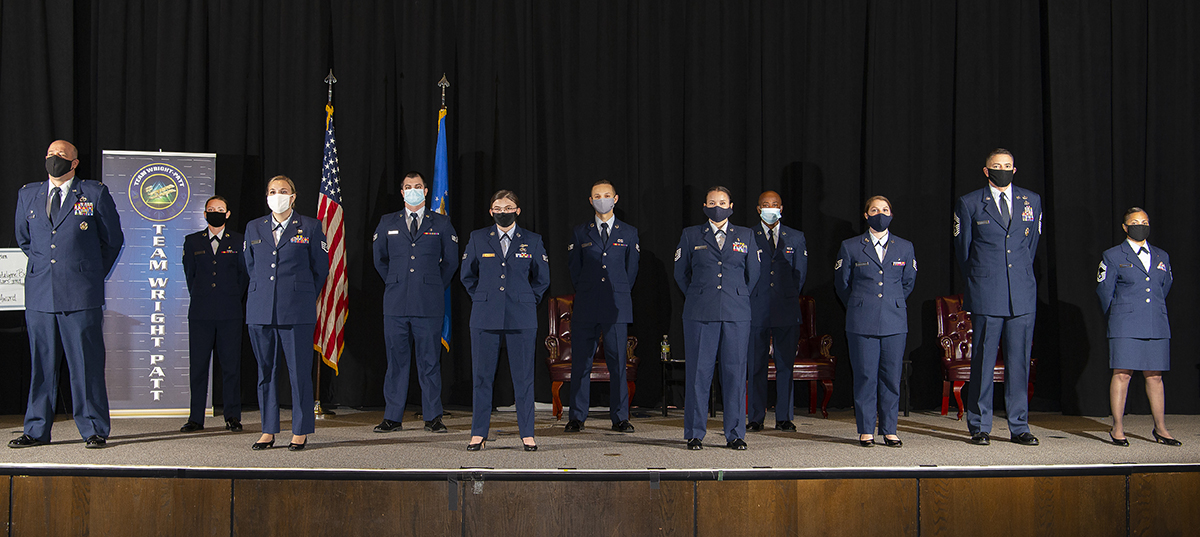 Eight Community College of the Air Force graduates pose with Col. Patrick Miller, 88th Air Base Wing and installation commander; Chief Master Sgt. Jason Shaffer, 88th ABW command chief; and Chief Master Sgt. Arwa Cavendar, 88th Medical Support Squadron superintendent, after their graduation ceremony Nov. 19 at the National Museum of the Air Force. Only eight of the 29 graduates were able to attend due to the pandemic and no guests were allowed. U.S. AIR FORCE PHOTO/R.J. ORIEZ